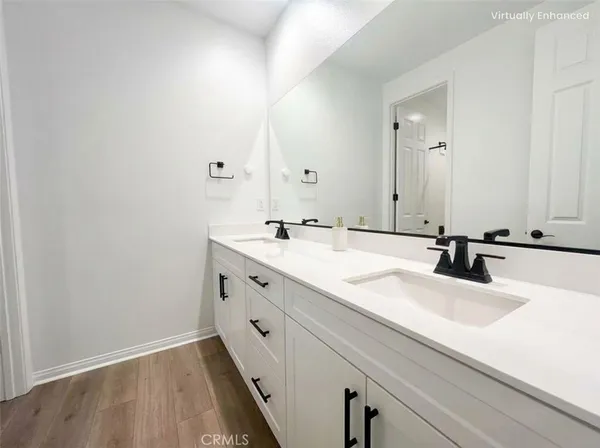 a bathroom with a double vanity sink and mirror