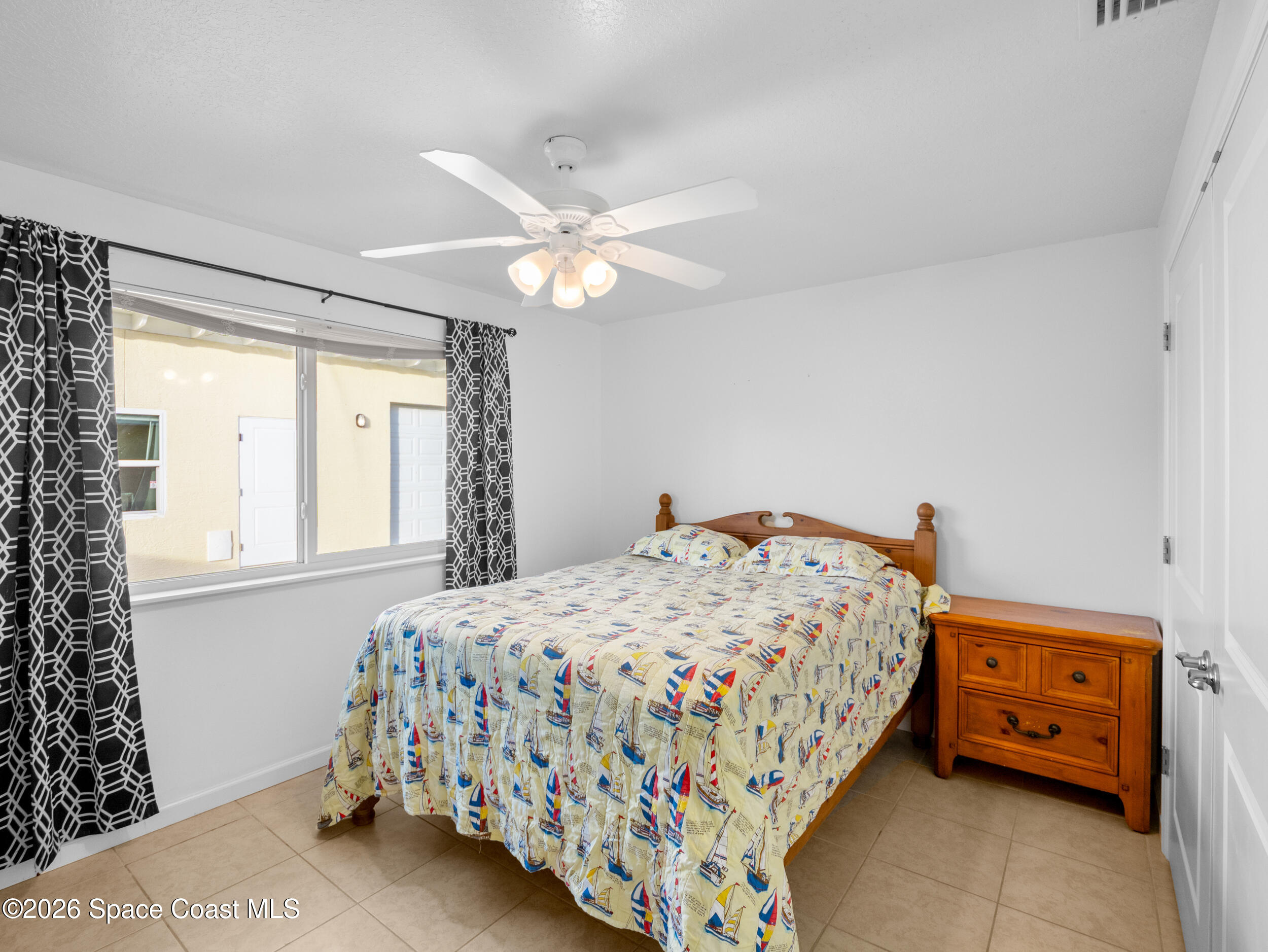 222 Rosa L Jones Drive Cocoa, FL 32922 - Photo 11 of 36 a bedroom with a bed and a chandelier