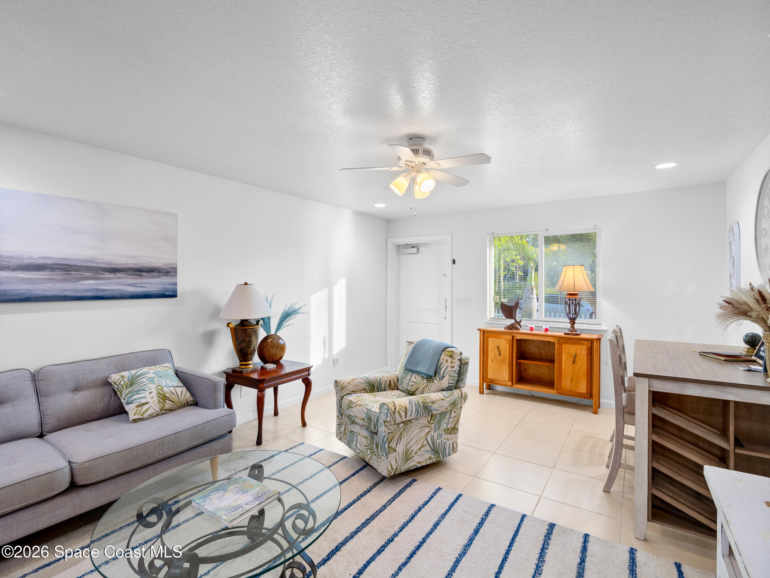 222 Rosa L Jones Drive Cocoa, FL 32922 - Photo 15 of 36 a living room with furniture and a dining table with wooden floor