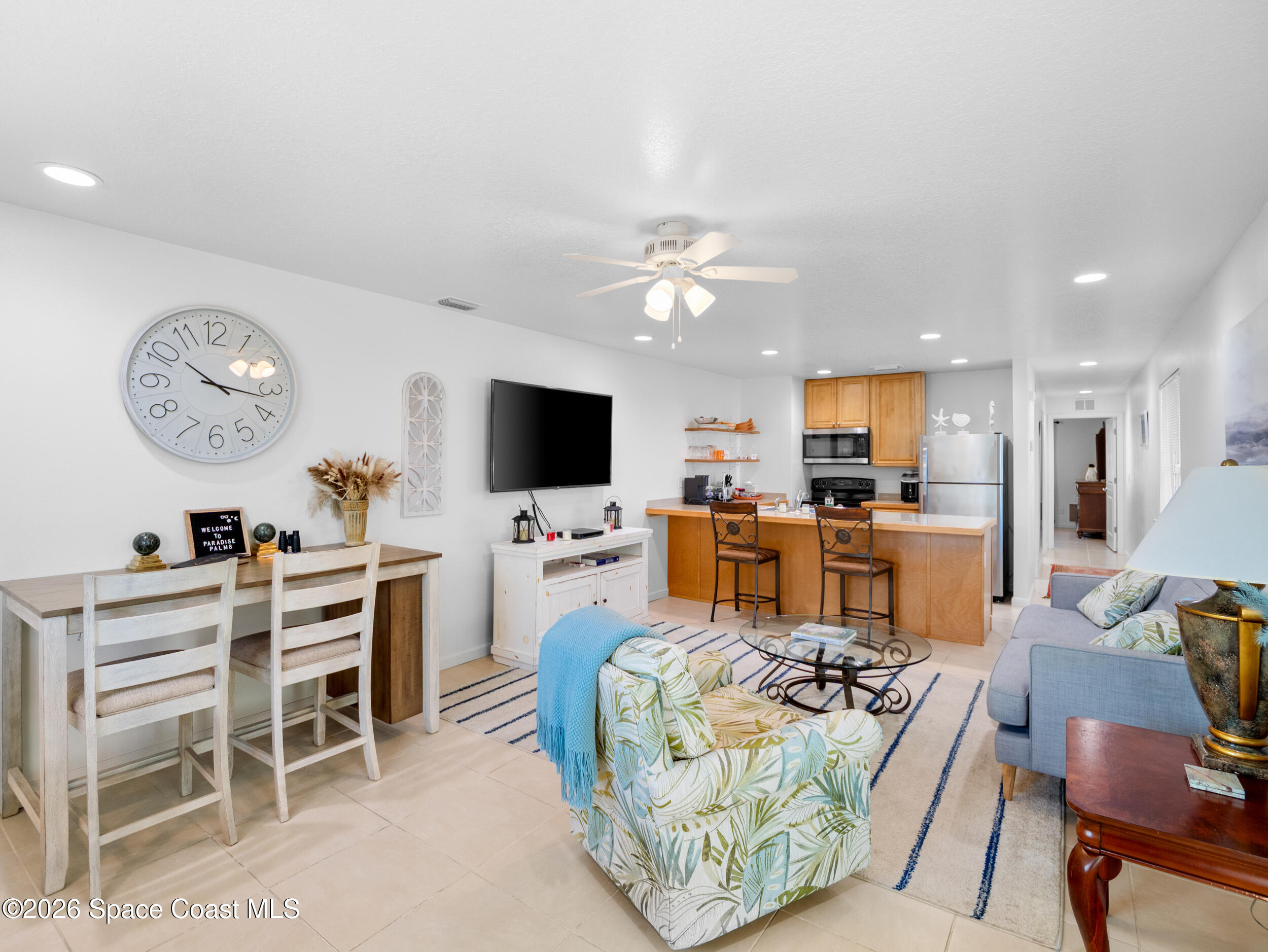 222 Rosa L Jones Drive Cocoa, FL 32922 - Photo 36 of 36 a living room with furniture a flat screen tv and kitchen view