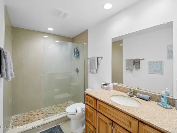 a view of a hallway with a large mirror