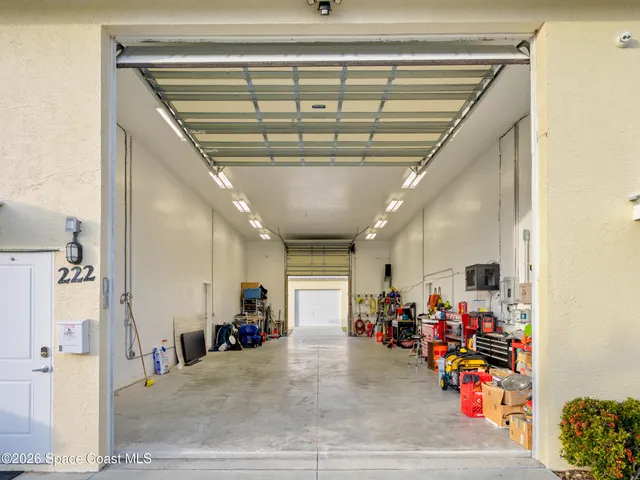 a backyard of a house with a garden and tree