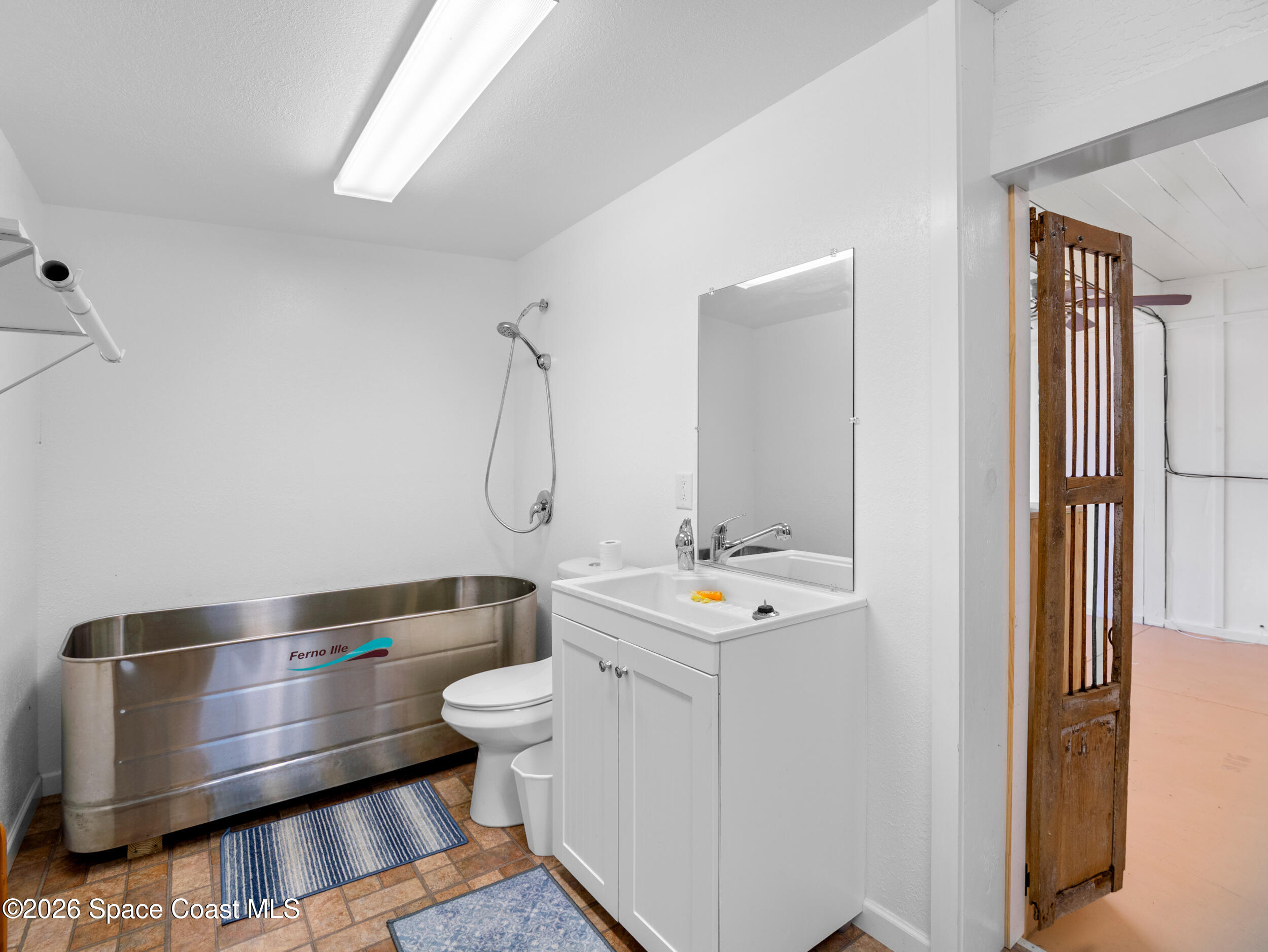 222 Rosa L Jones Drive Cocoa, FL 32922 - Photo 25 of 36 a bathroom with a sink and a mirror