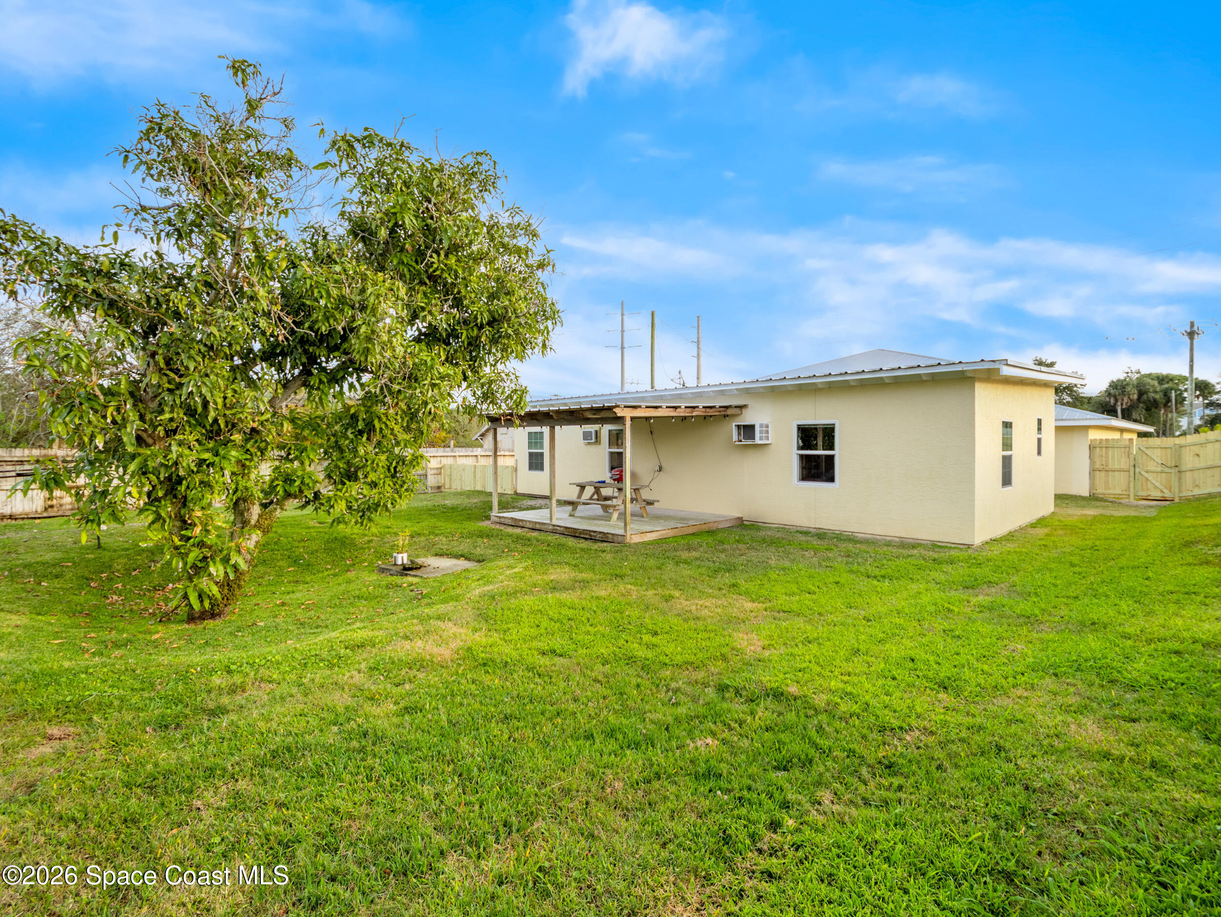 222 Rosa L Jones Drive Cocoa, FL 32922 - Photo 28 of 36 a backyard of a house with a garden and tree