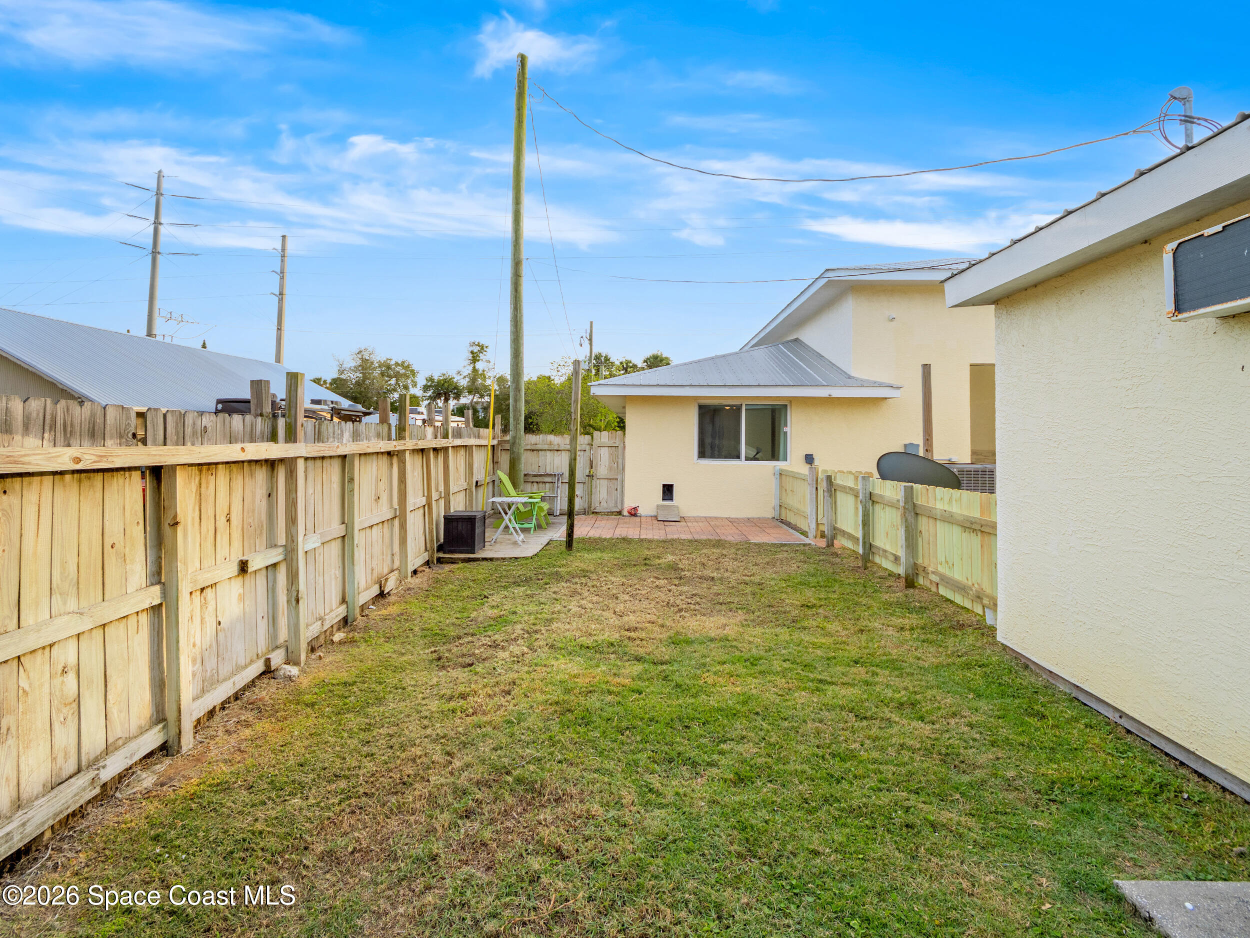 222 Rosa L Jones Drive Cocoa, FL 32922 - Photo 29 of 36 a view of a patio with a table chairs and wooden fence