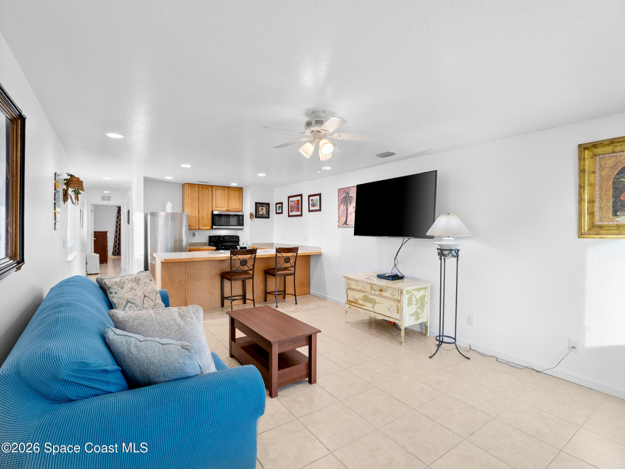 222 Rosa L Jones Drive Cocoa, FL 32922 - Photo 8 of 36 a living room with furniture and a flat screen tv