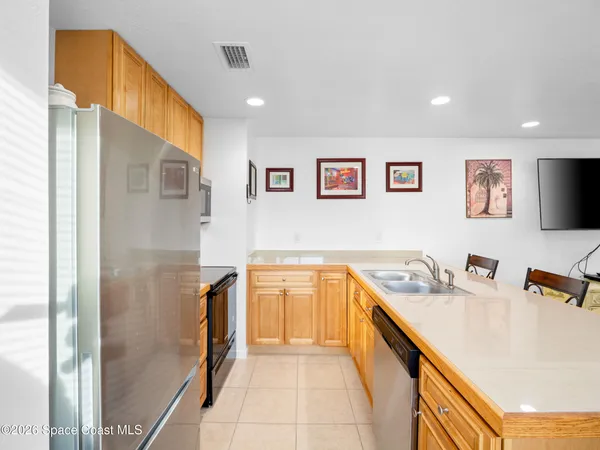 a living room with furniture and a dining table with wooden floor