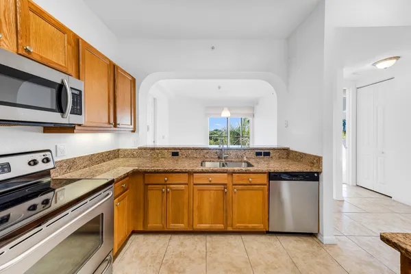 a kitchen with a sink stove and cabinets