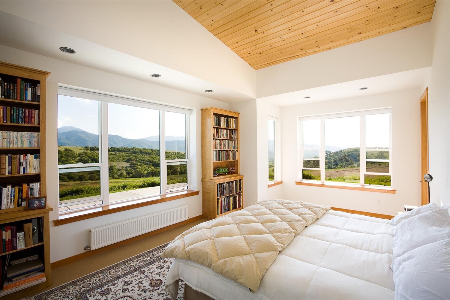 2645 Butler Creek Road Ashland, OR 97520 - Photo 7 of 17 a bed room with a bed and a large window