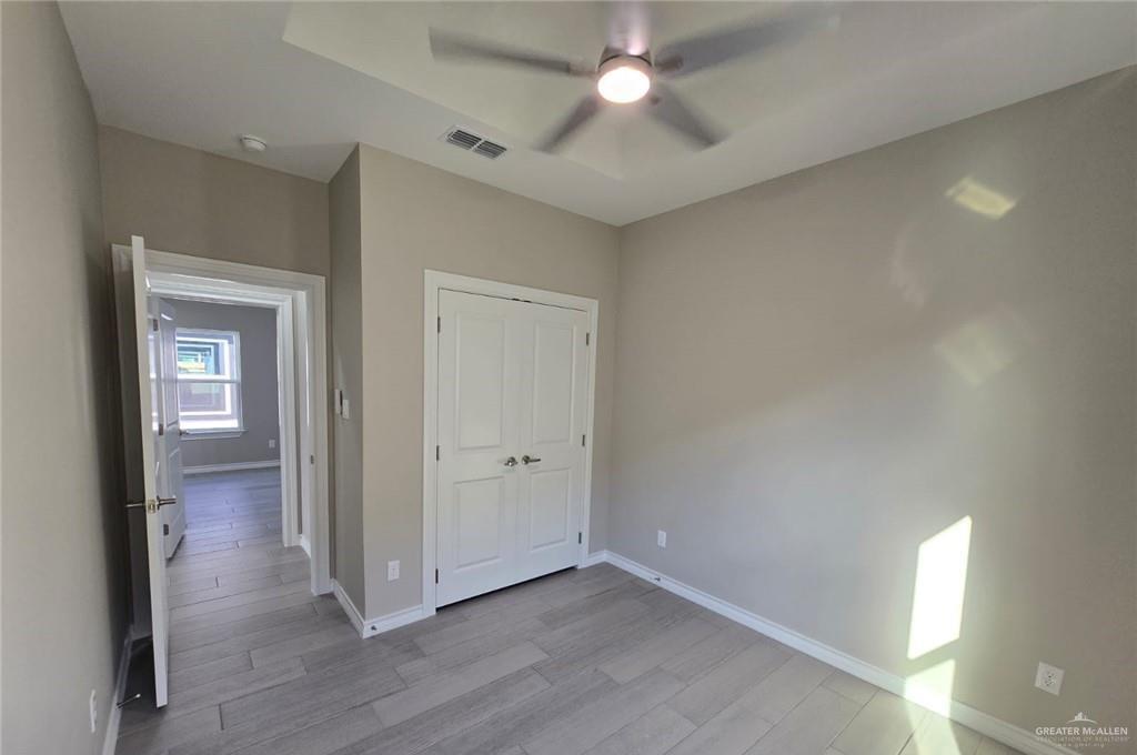 1420 South Xanthia Street, Unit 3 Alton, TX 78573 - Photo 11 of 12 wooden floor in an empty room with a window