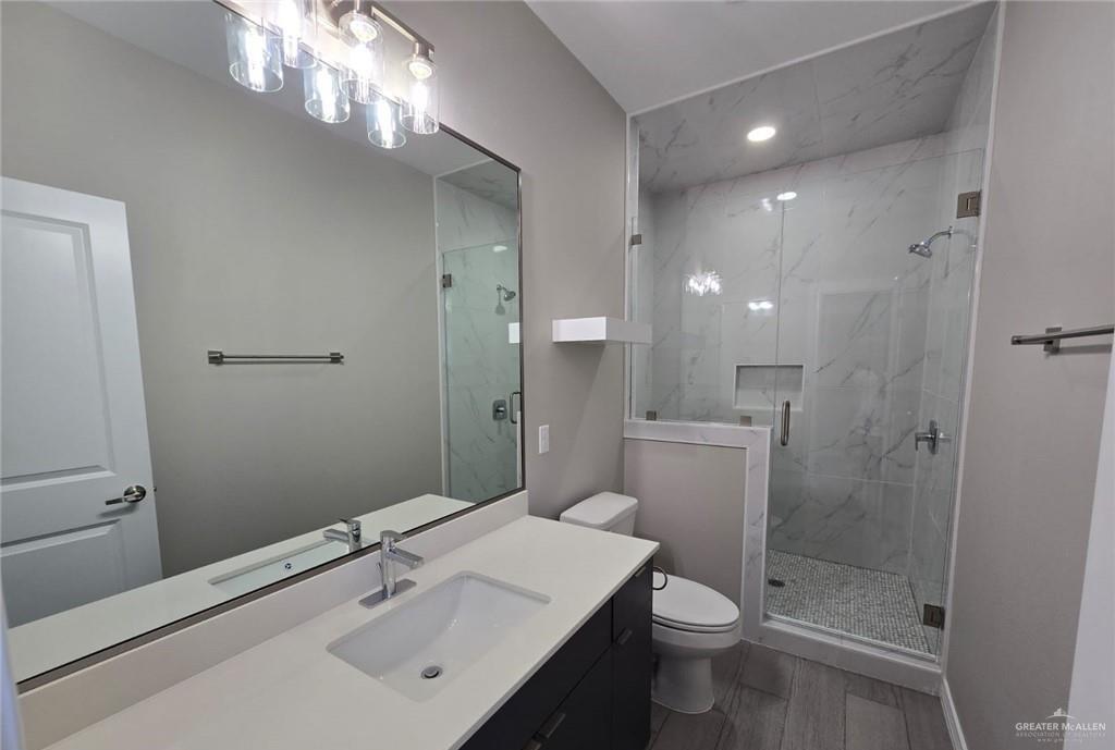 1420 South Xanthia Street, Unit 3 Alton, TX 78573 - Photo 8 of 12 a bathroom with a sink a toilet and shower