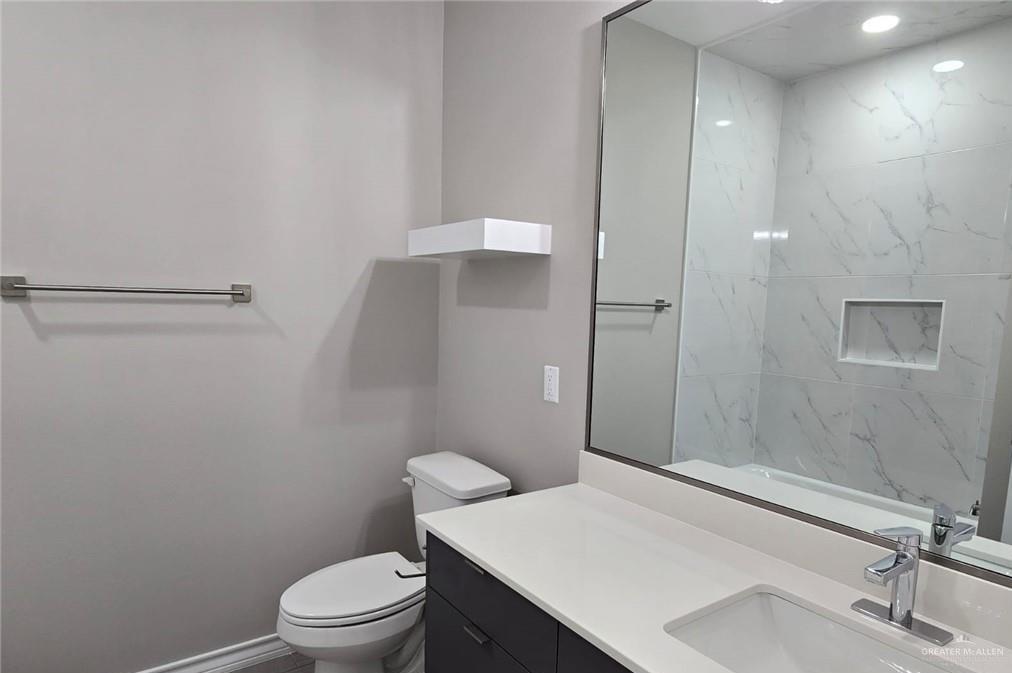 1420 South Xanthia Street, Unit 3 Alton, TX 78573 - Photo 9 of 12 a bathroom with a sink a toilet and shower