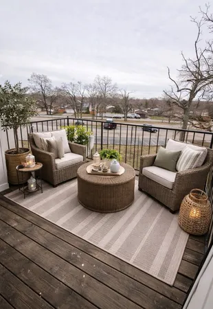 a view of a roof deck with couches and a potted plant