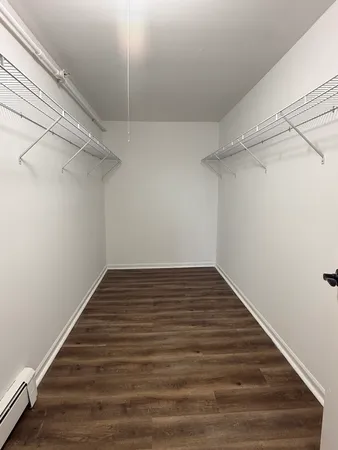 a view of a room with wooden floor
