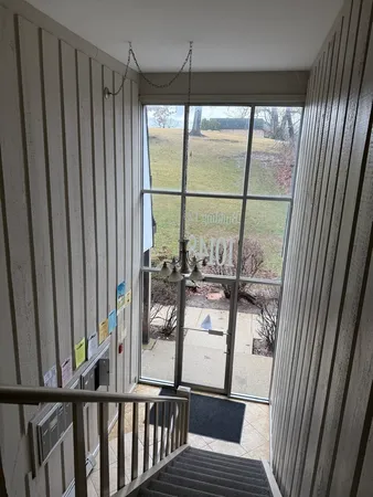a view of a room with wooden floor and windows