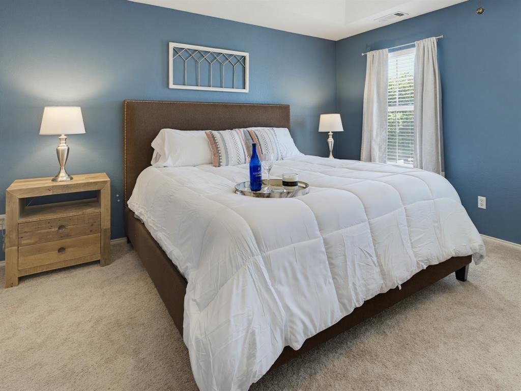 13268 Fencerow Road Fort Worth, TX 76244 - Photo 10 of 25 Bedroom featuring blue painted walls, neutral carpet, and a window with blinds