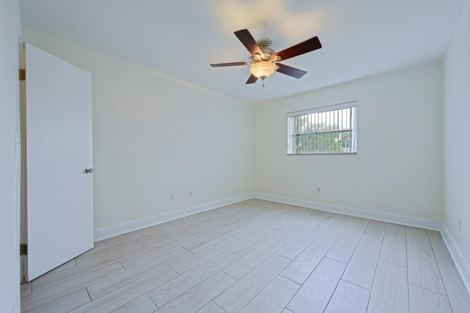 1505 Crescent Circle, Unit A8 Lake Park, FL 33403 - Photo 11 of 32 an empty room with windows