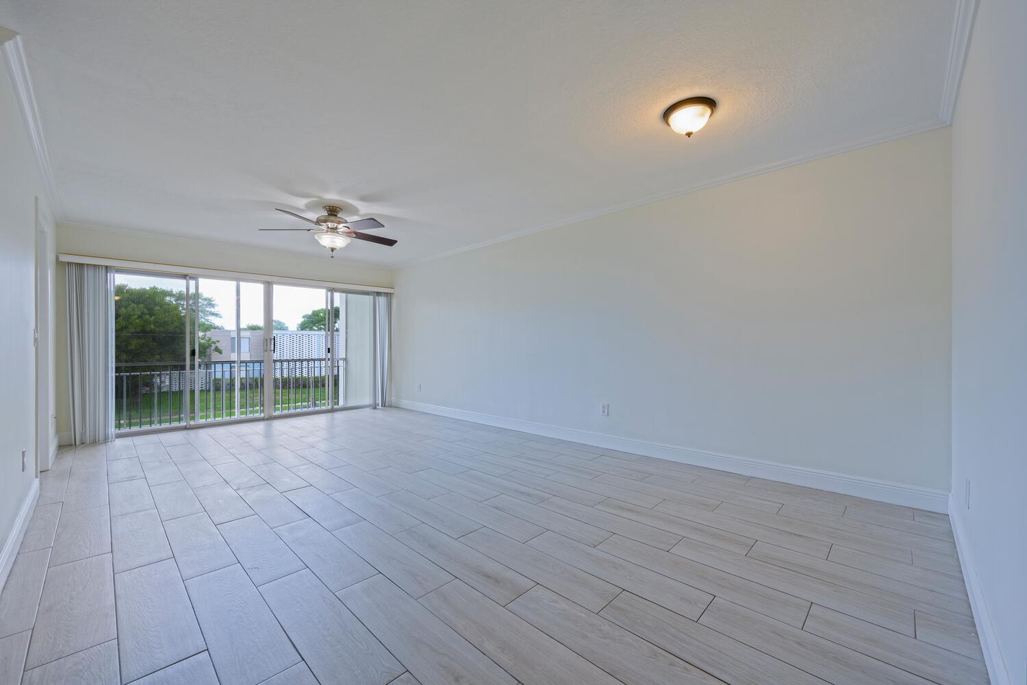 1505 Crescent Circle, Unit A8 Lake Park, FL 33403 - Photo 2 of 32 an empty room with wooden floor and windows