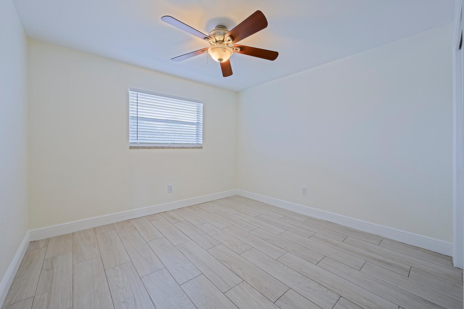 1505 Crescent Circle, Unit A8 Lake Park, FL 33403 - Photo 7 of 32 wooden floor in an empty room with a window