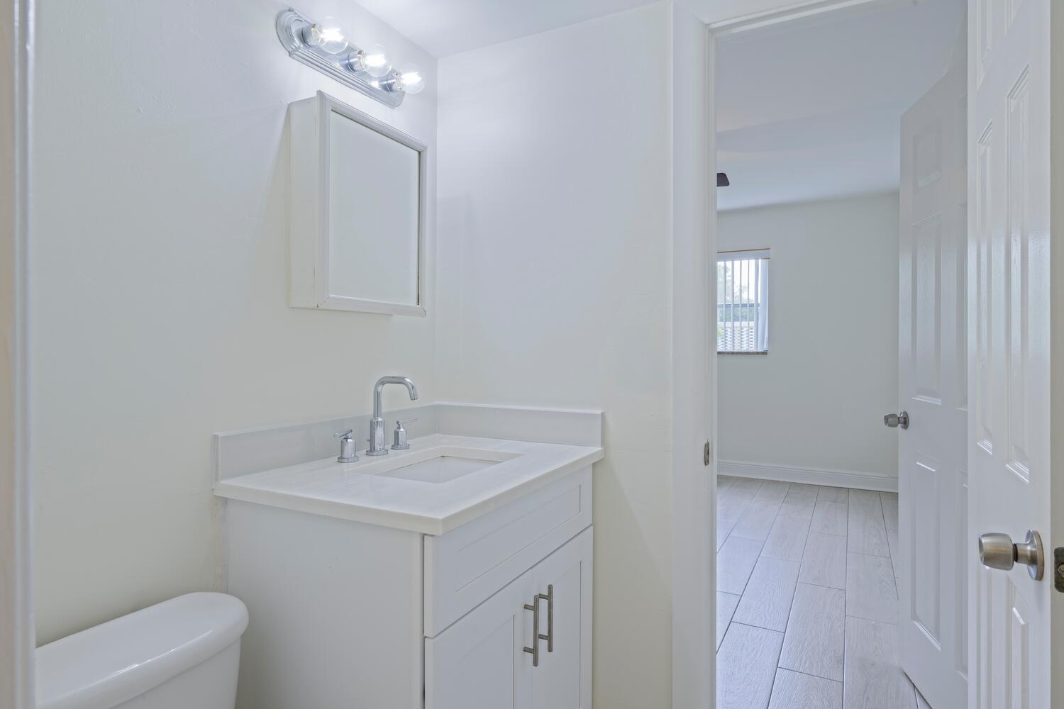 1505 Crescent Circle, Unit A8 Lake Park, FL 33403 - Photo 10 of 32 a bathroom with a sink a toilet and shower