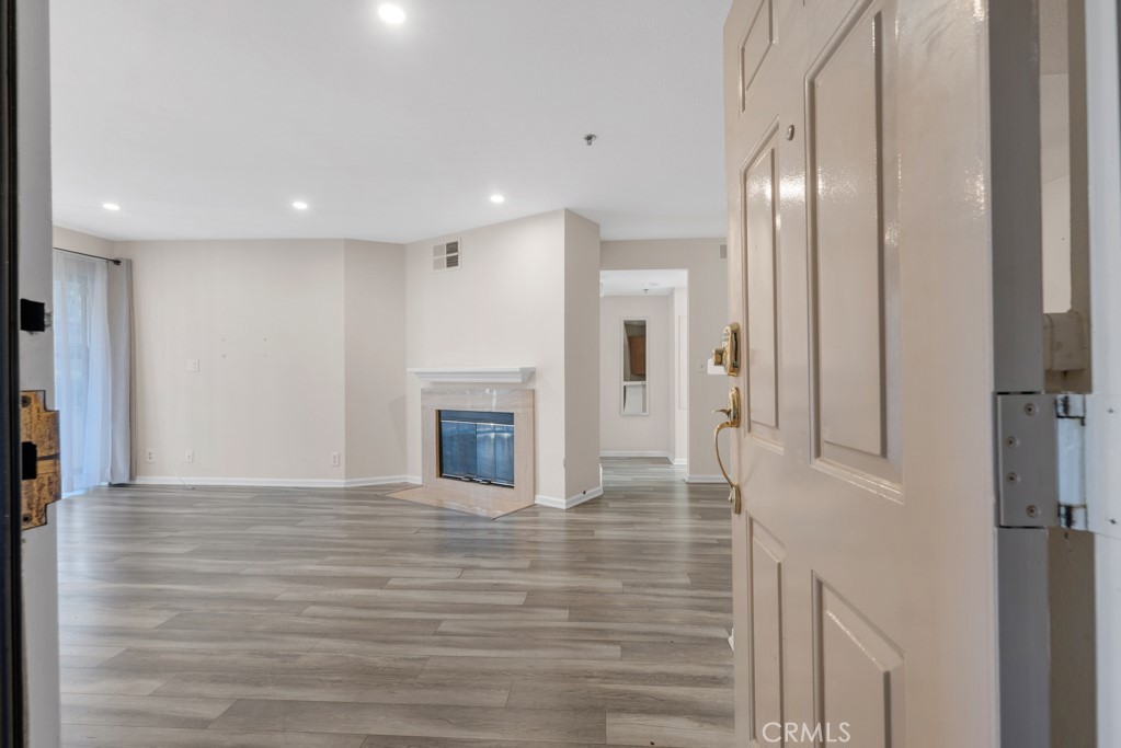 5744 Oak Bend Lane, Unit 203 Oak Park, CA 91377 - Photo 1 of 45 a view of a hallway with wooden floor