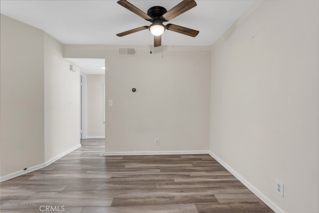 5744 Oak Bend Lane, Unit 203 Oak Park, CA 91377 - Photo 13 of 45 a view of room with hardwood floor and ceiling fan