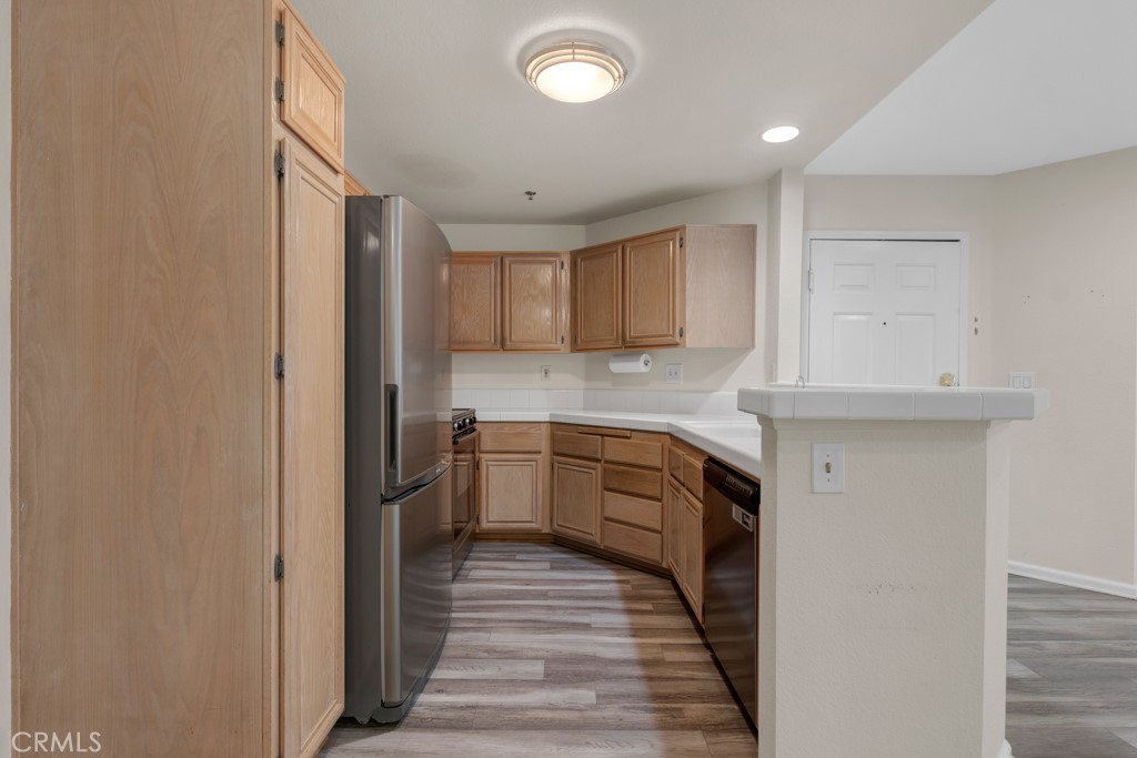 5744 Oak Bend Lane, Unit 203 Oak Park, CA 91377 - Photo 19 of 45 a kitchen with granite countertop a sink and cabinets