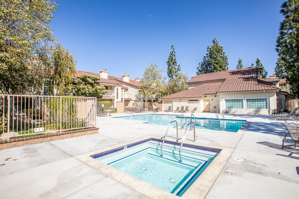 5744 Oak Bend Lane, Unit 203 Oak Park, CA 91377 - Photo 31 of 45 a view of a house with a swimming pool