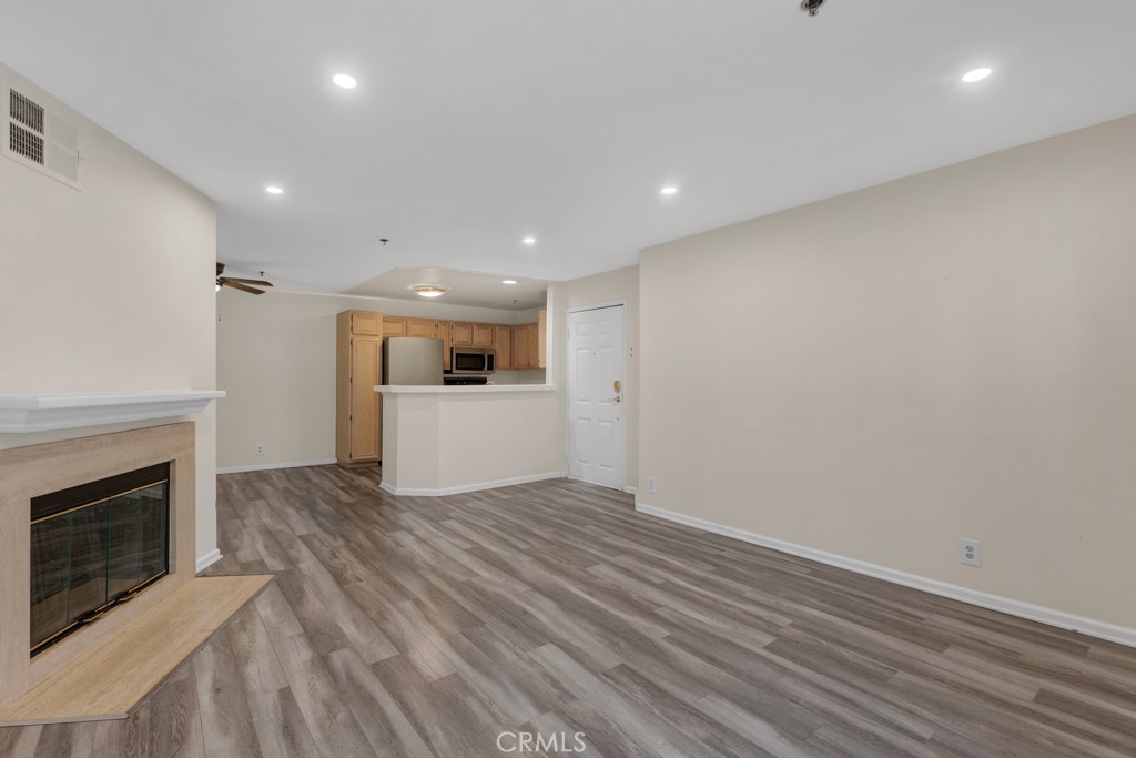 5744 Oak Bend Lane, Unit 203 Oak Park, CA 91377 - Photo 10 of 45 a view of a kitchen with a sink and a fireplace