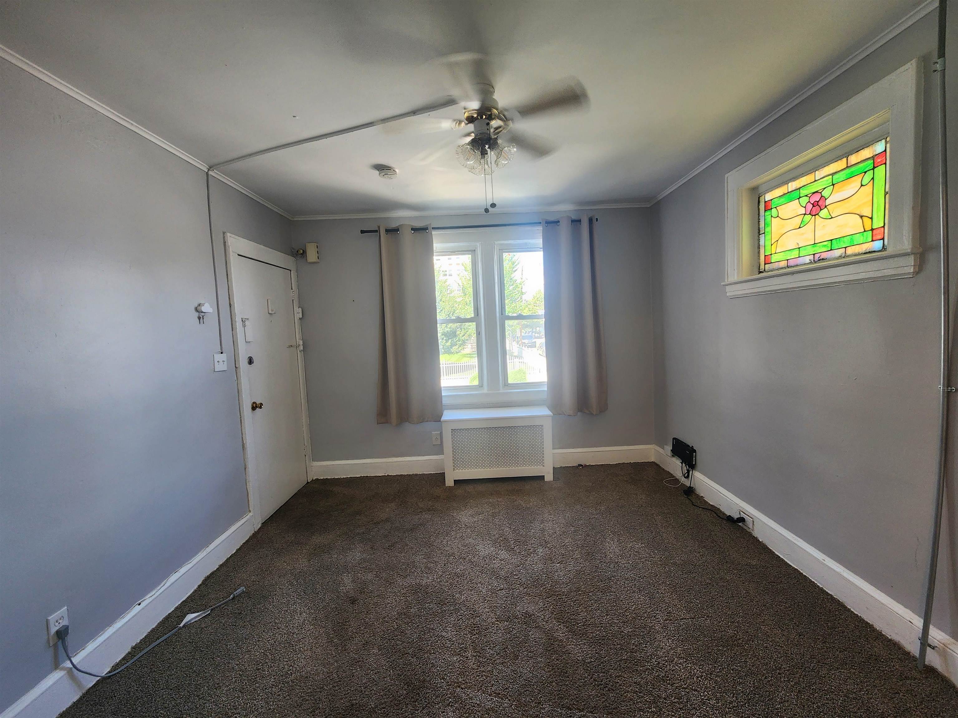 261 Centre Avenue, Unit 1 Secaucus, NJ 07094 - Photo 7 of 11 an empty room with windows and fan