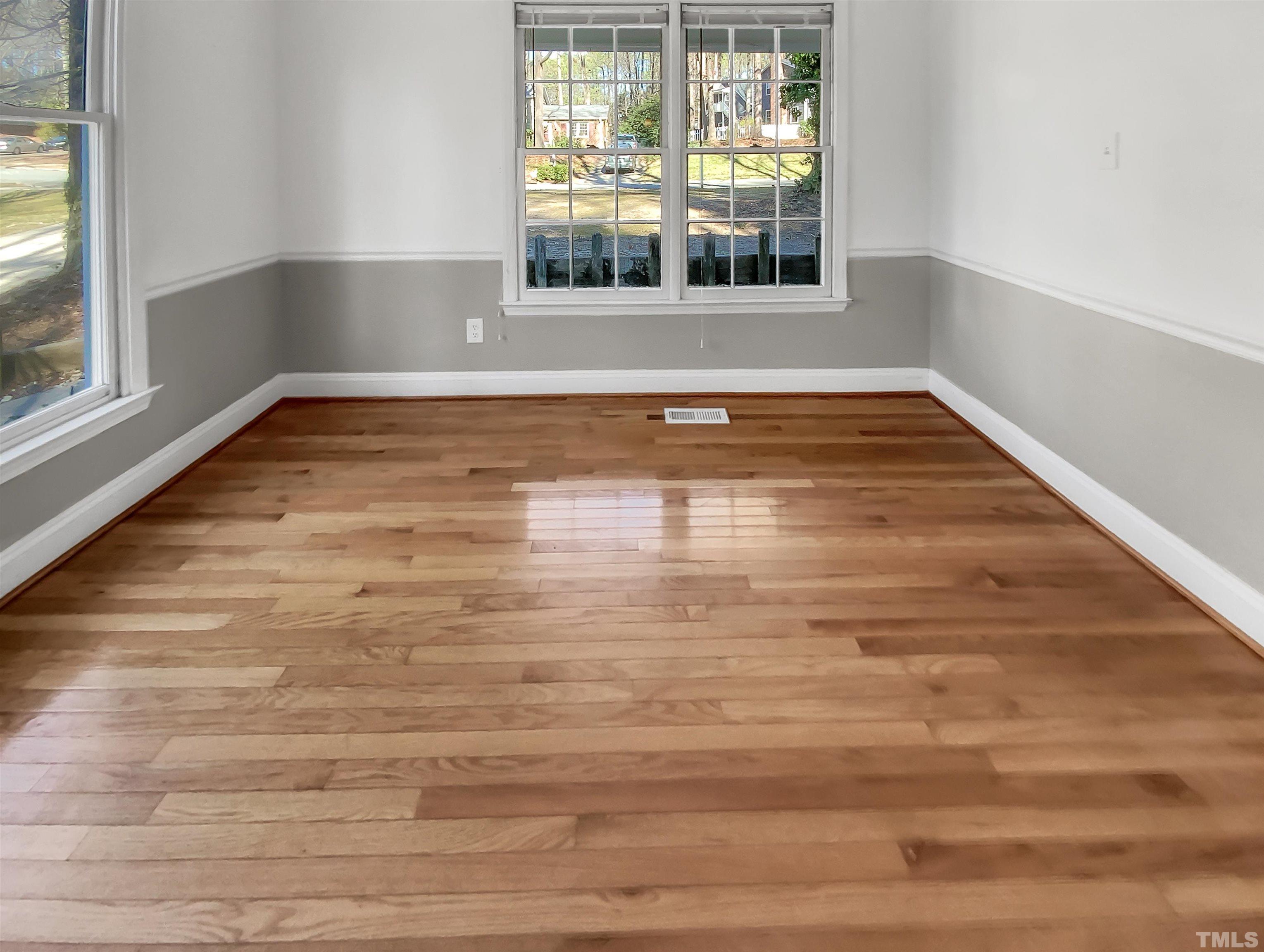 1007 Castalia Drive Cary, NC 27513 - Photo 12 of 17 a view of an empty room with wooden floor and a window