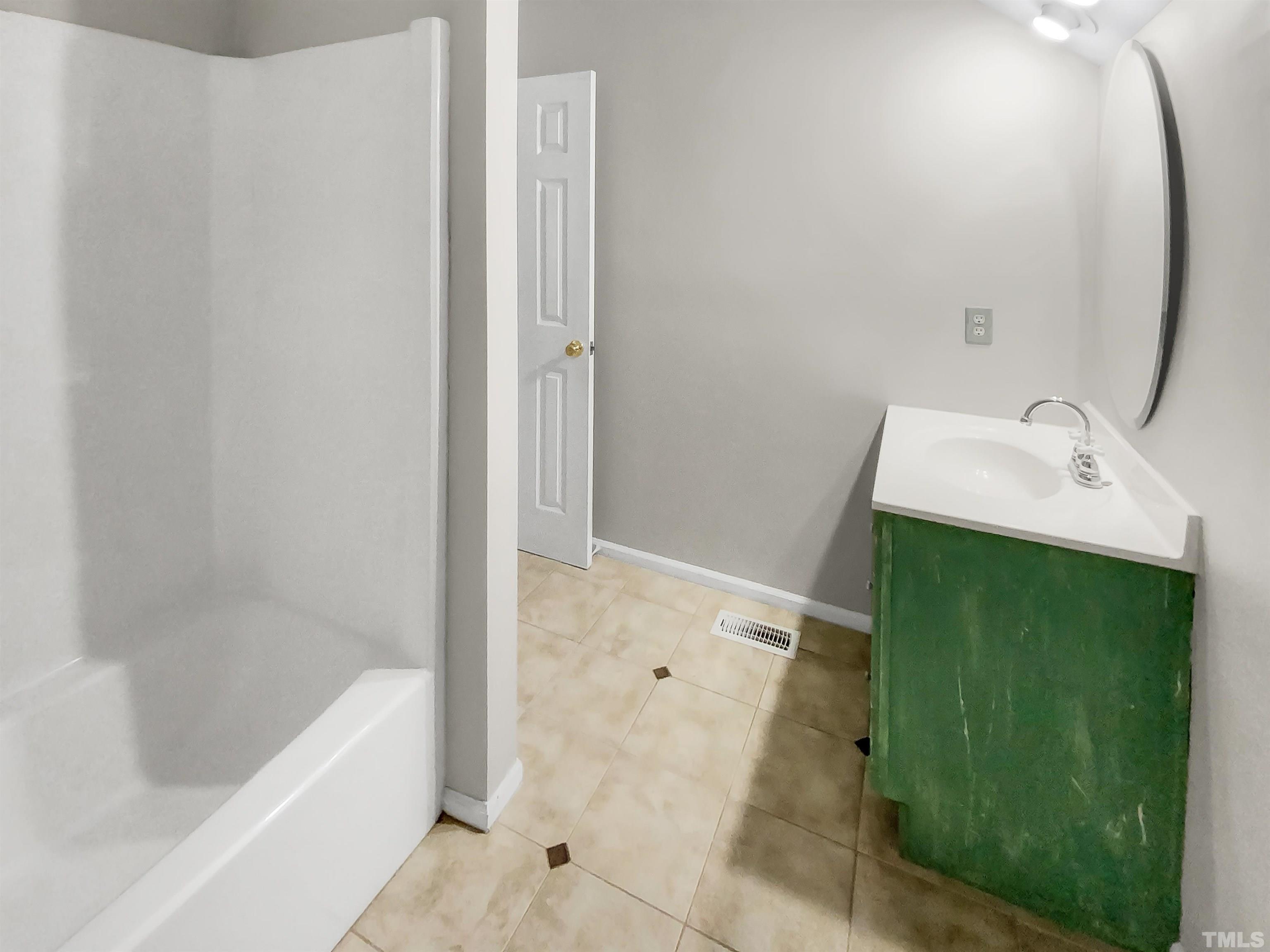 1007 Castalia Drive Cary, NC 27513 - Photo 16 of 17 a bathroom with a sink and a bathtub