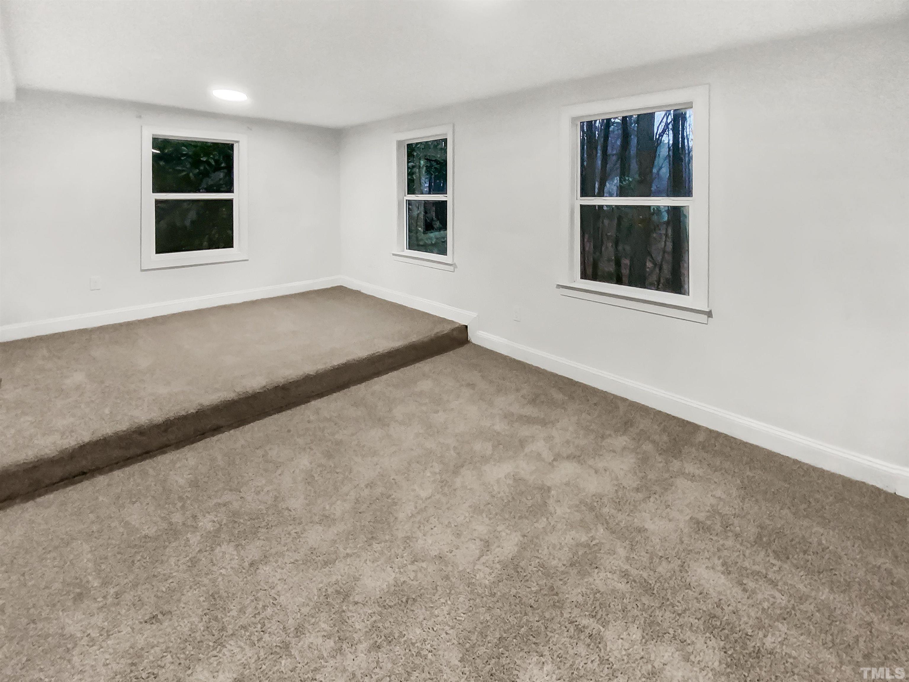 1007 Castalia Drive Cary, NC 27513 - Photo 2 of 17 an empty room with windows