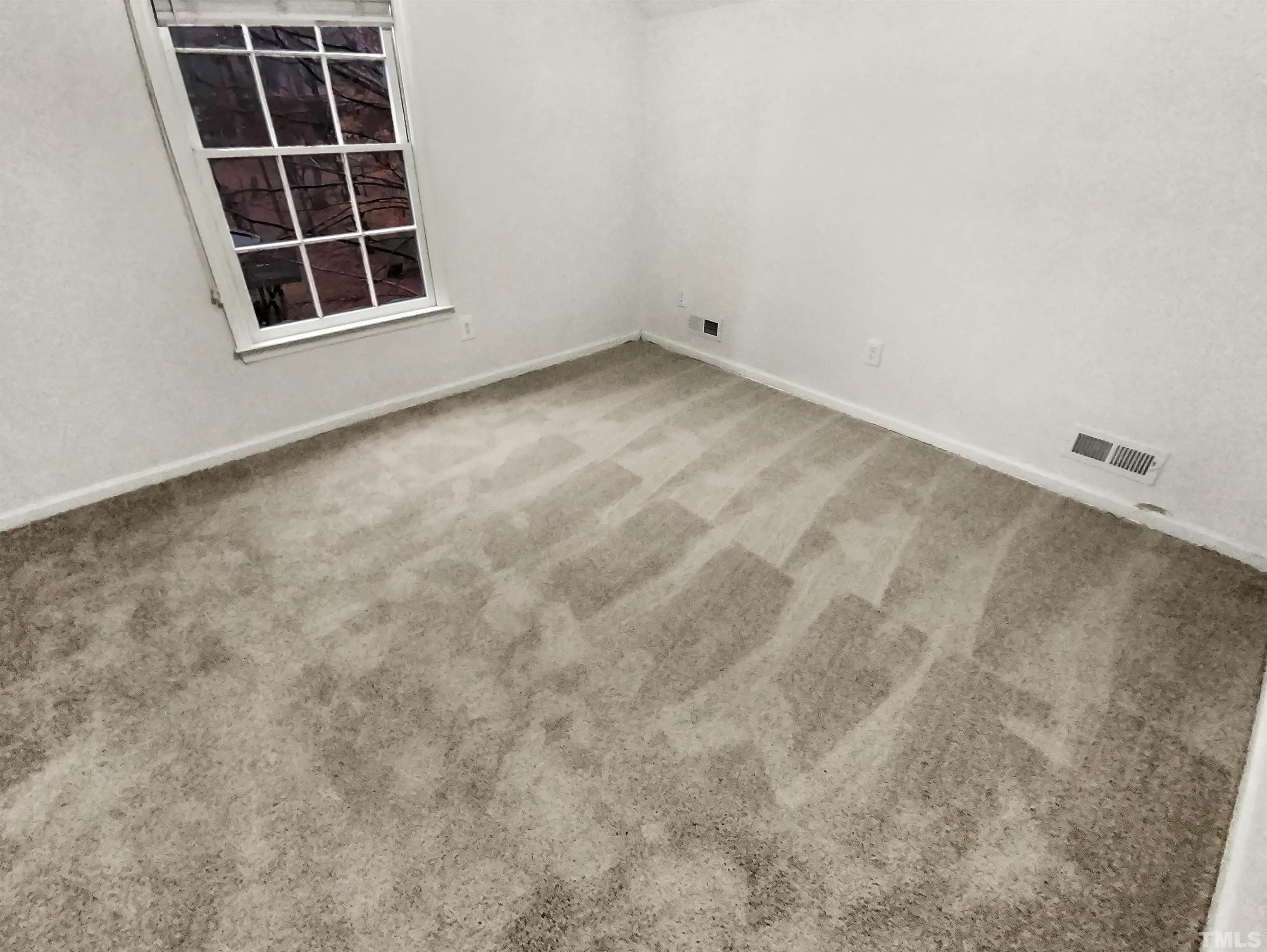 1007 Castalia Drive Cary, NC 27513 - Photo 3 of 17 a view of an empty room with a window