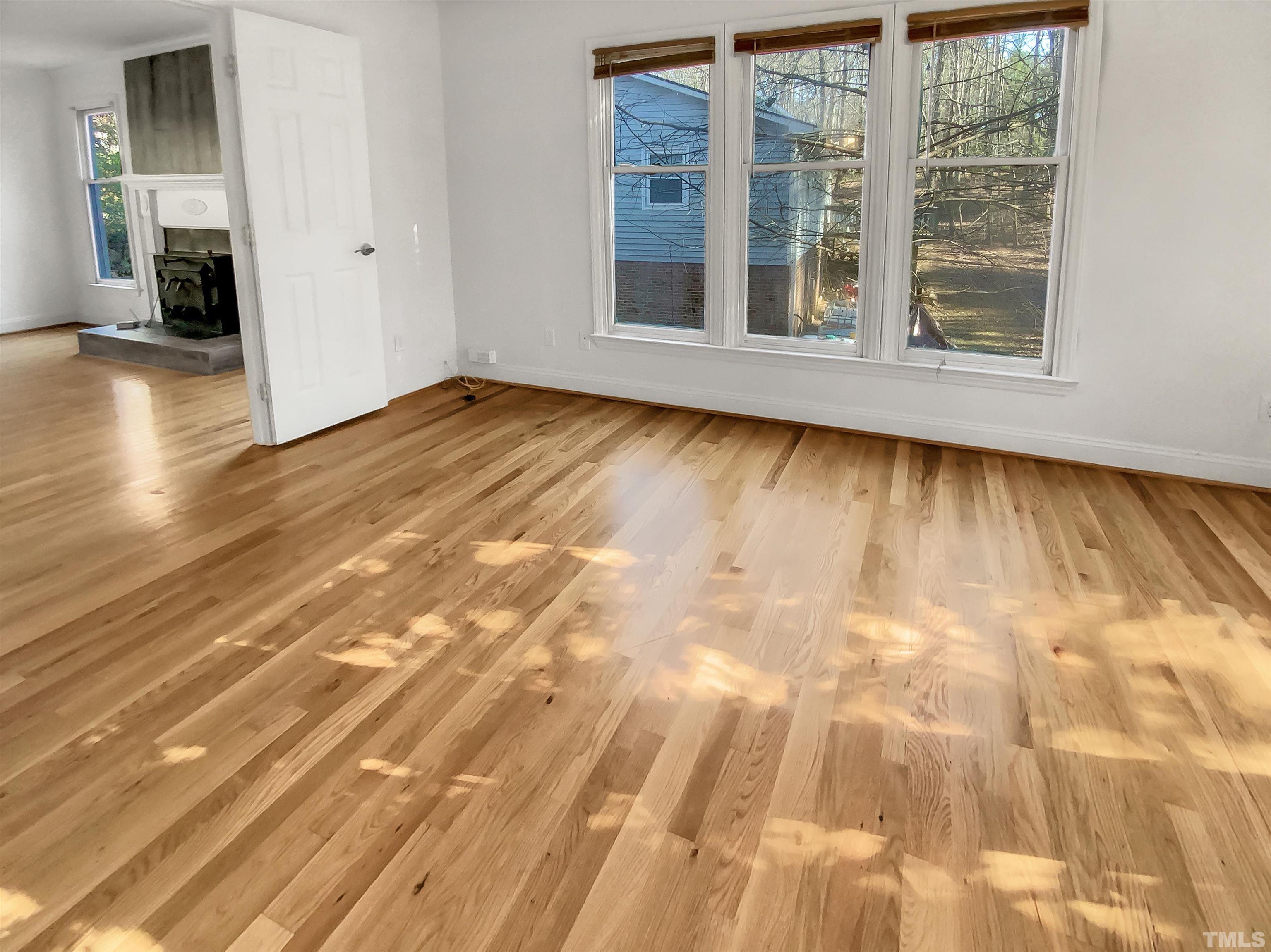 1007 Castalia Drive Cary, NC 27513 - Photo 6 of 17 an empty room with wooden floor and windows