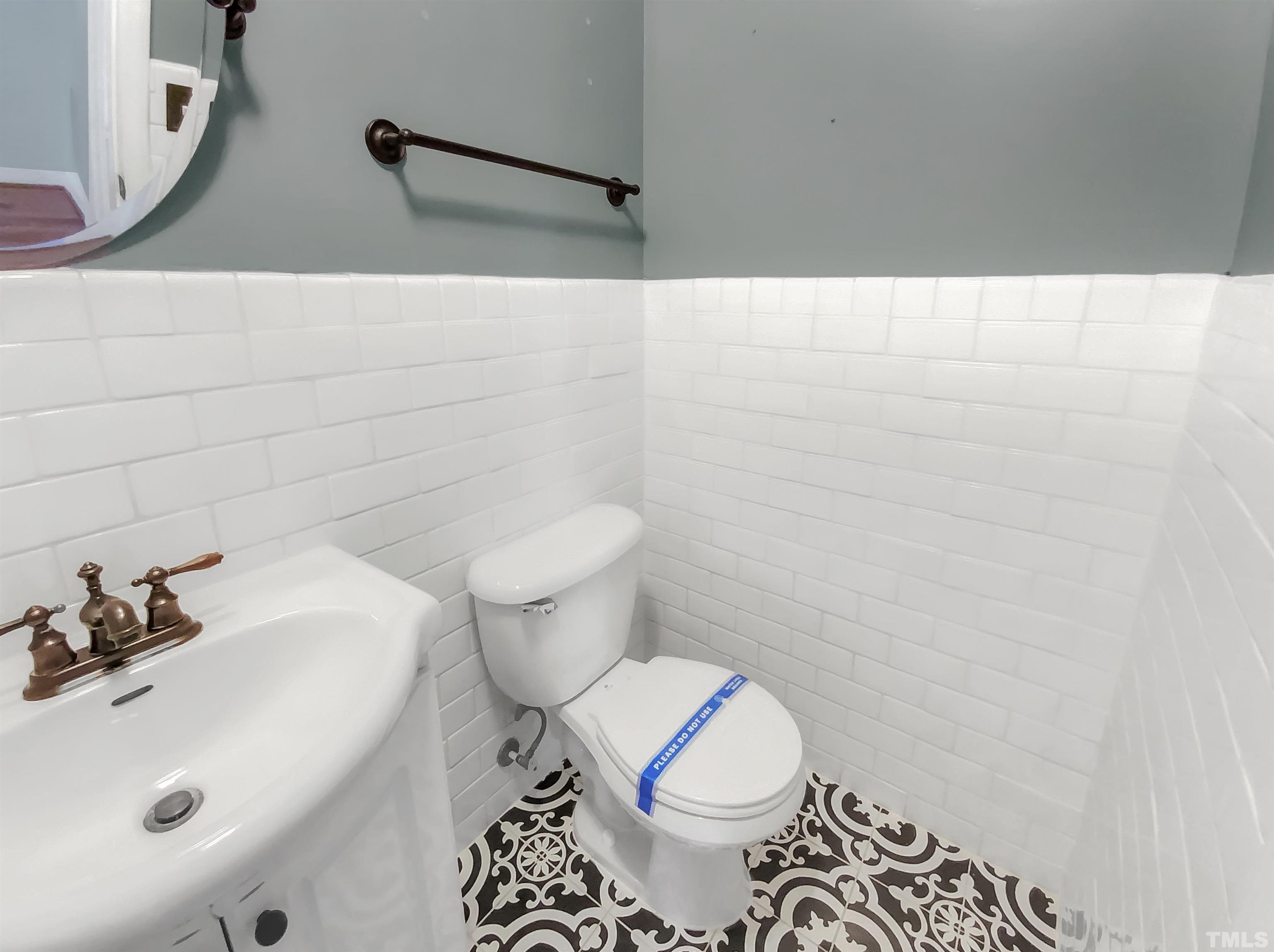 1007 Castalia Drive Cary, NC 27513 - Photo 9 of 17 a bathroom with a sink a toilet and a mirror