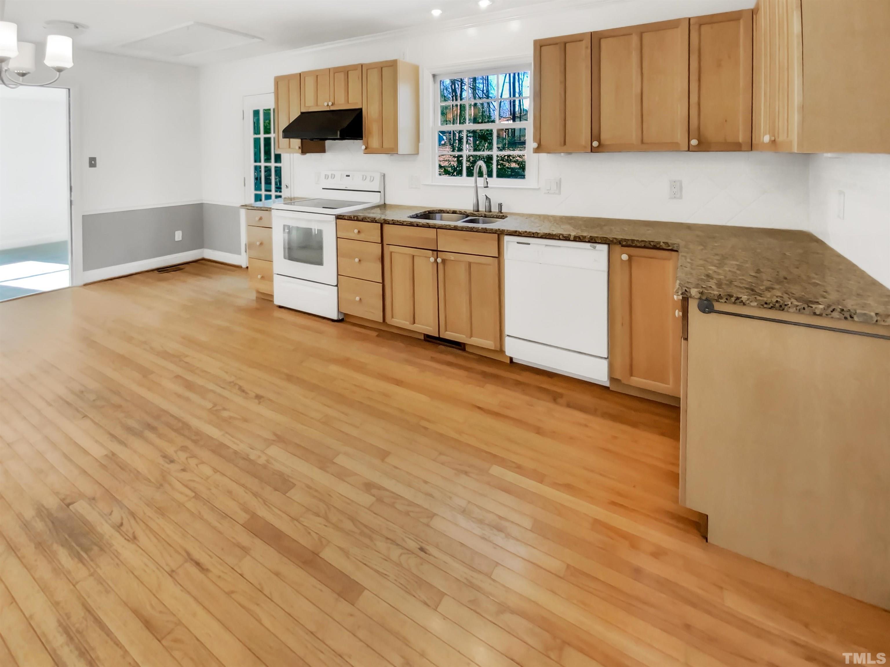 1007 Castalia Drive Cary, NC 27513 - Photo 10 of 17 a kitchen with granite countertop a stove top oven sink and cabinets