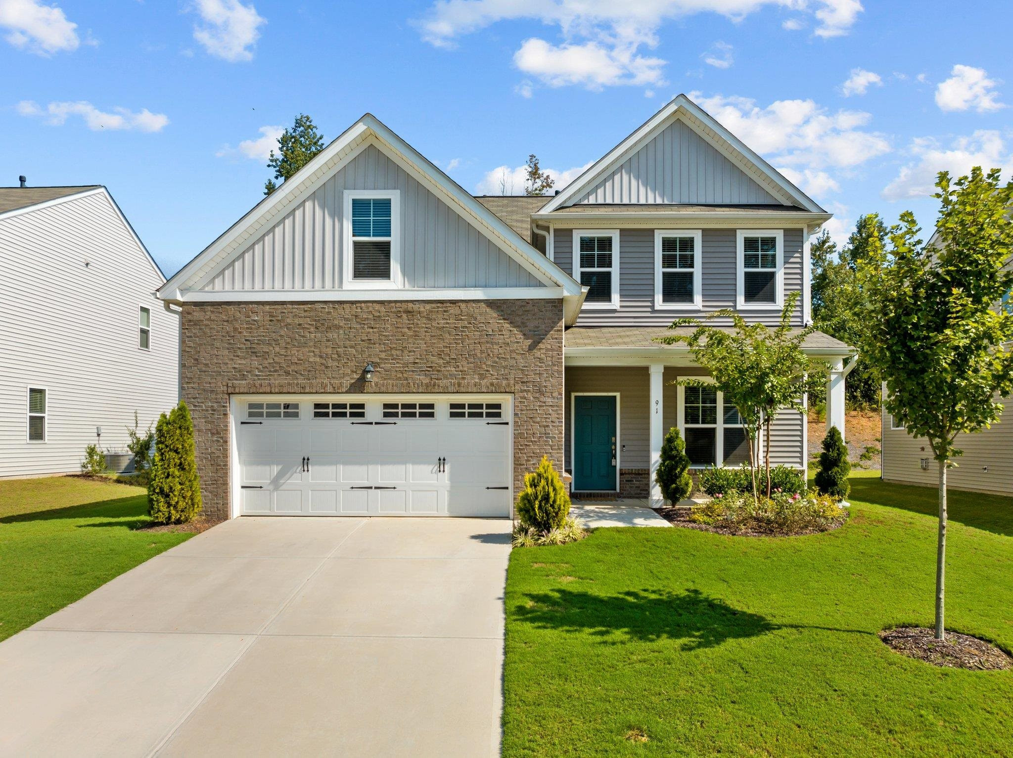 91 Stromness Path Clayton, NC 27527 - Photo 1 of 48 a view of a white house with a big yard and potted plants