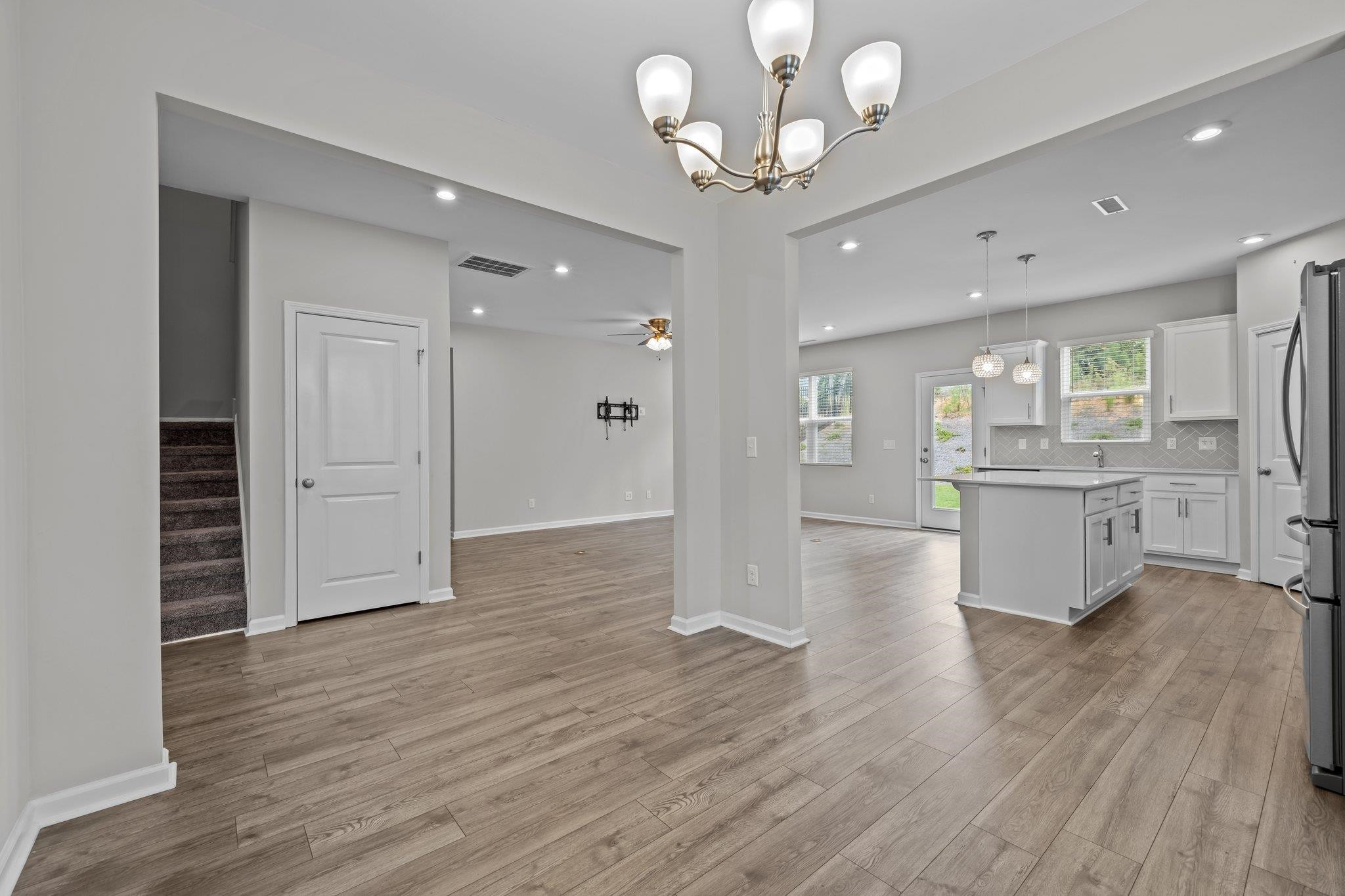 91 Stromness Path Clayton, NC 27527 - Photo 12 of 48 a view of a hallway with wooden floor and a kitchen