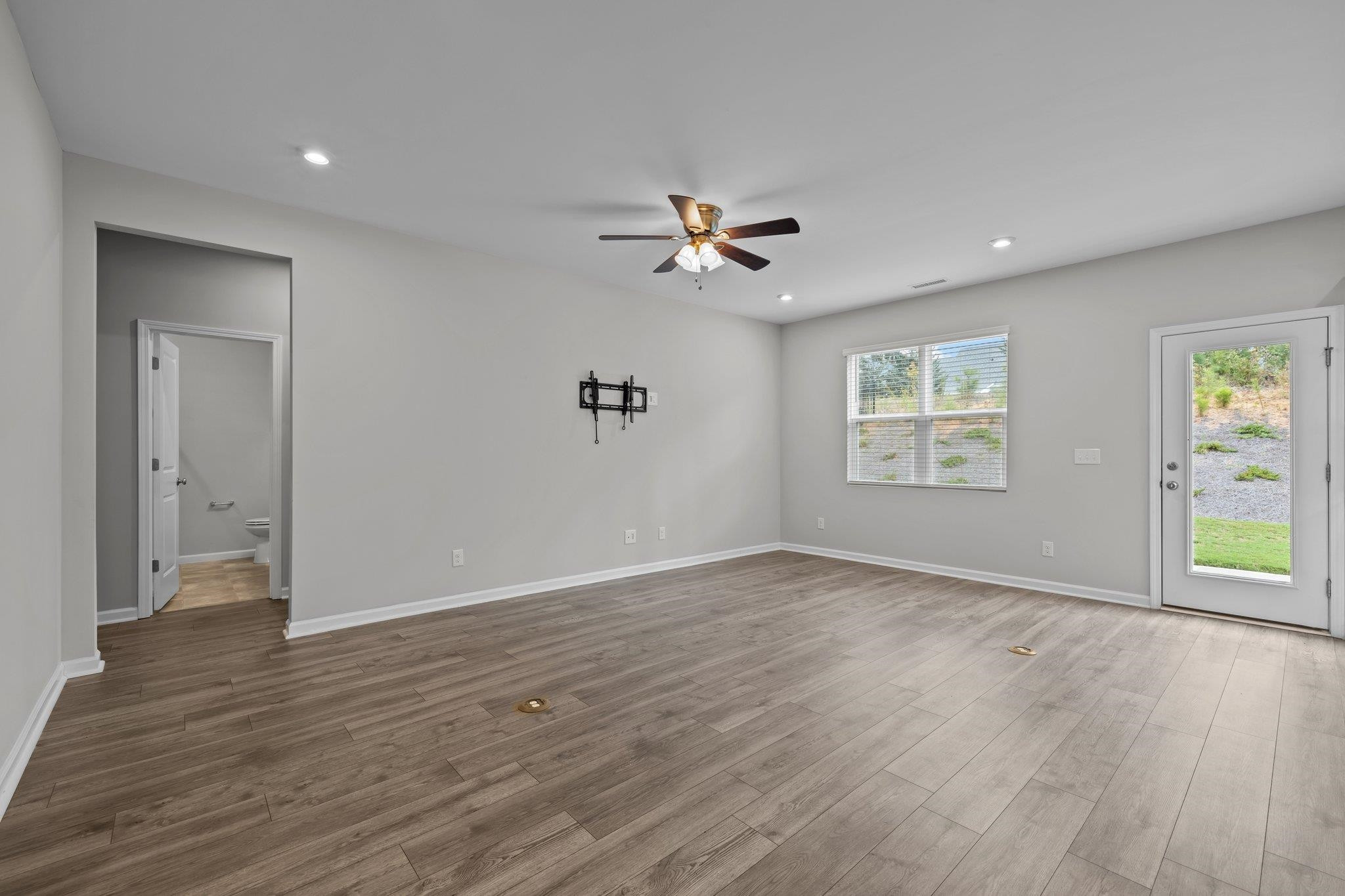 91 Stromness Path Clayton, NC 27527 - Photo 15 of 48 an empty room with wooden floor and windows