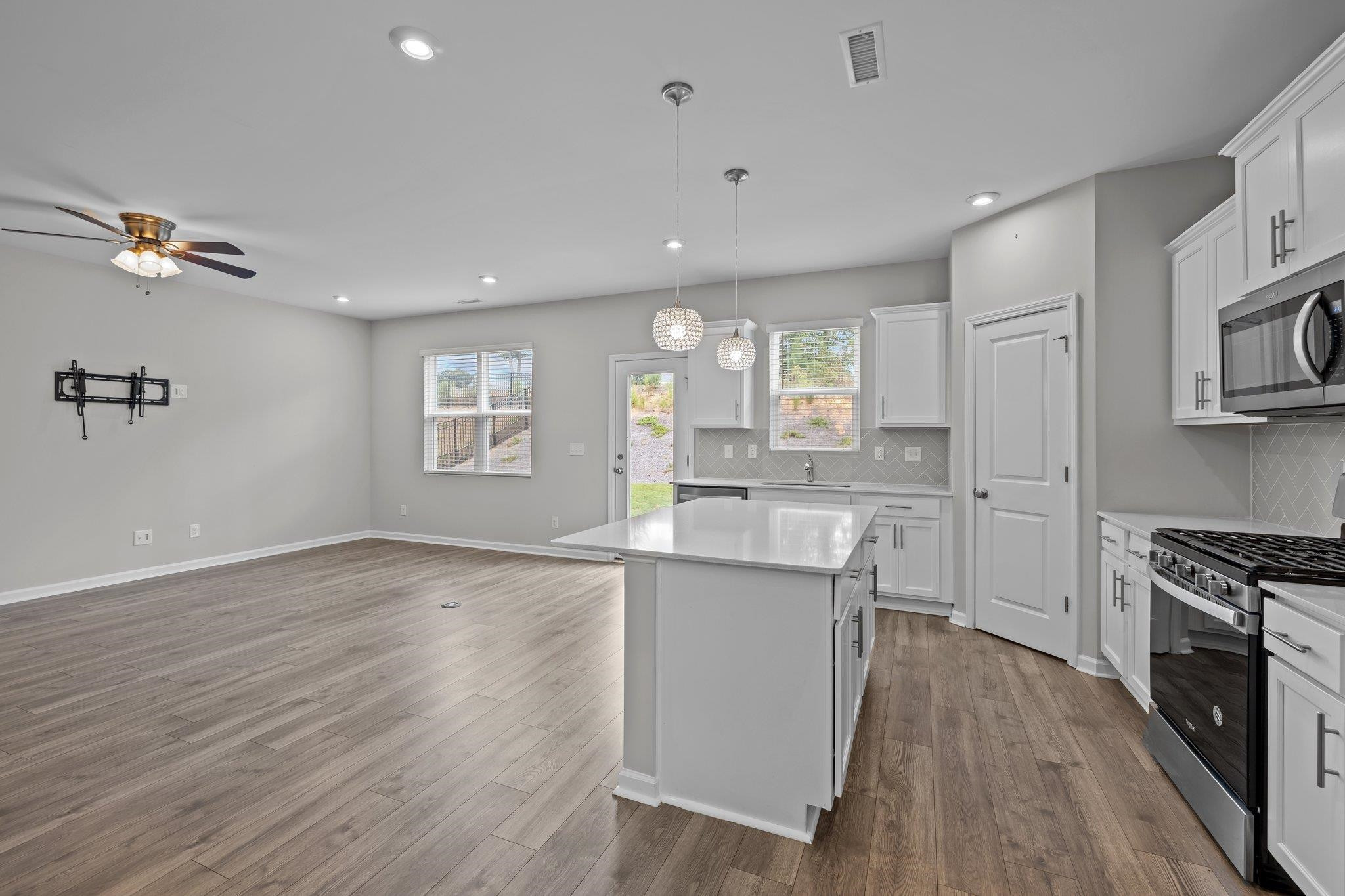 91 Stromness Path Clayton, NC 27527 - Photo 19 of 48 a kitchen with kitchen island a sink stainless steel appliances and cabinets
