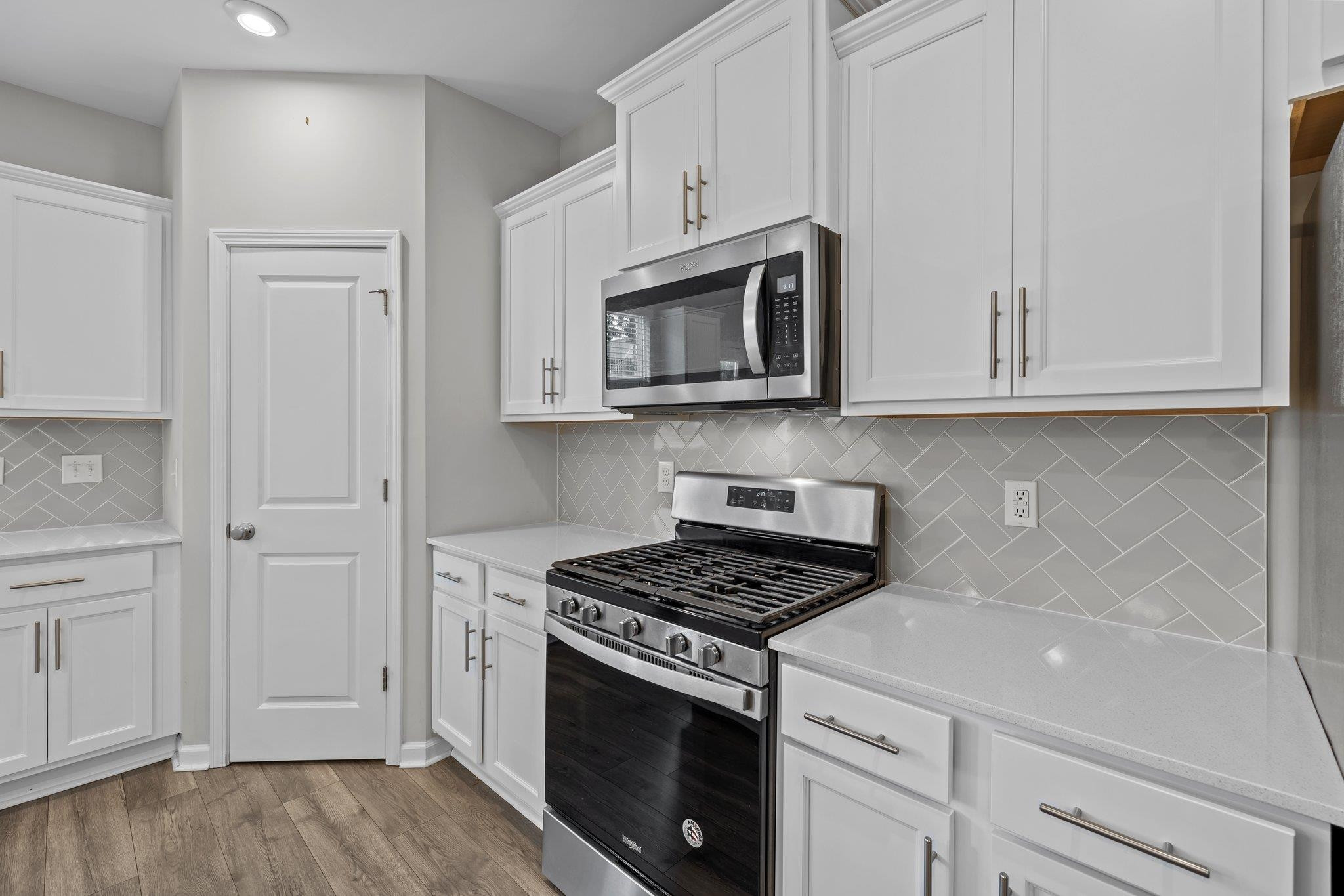 91 Stromness Path Clayton, NC 27527 - Photo 20 of 48 a kitchen with granite countertop white cabinets and stainless steel appliances