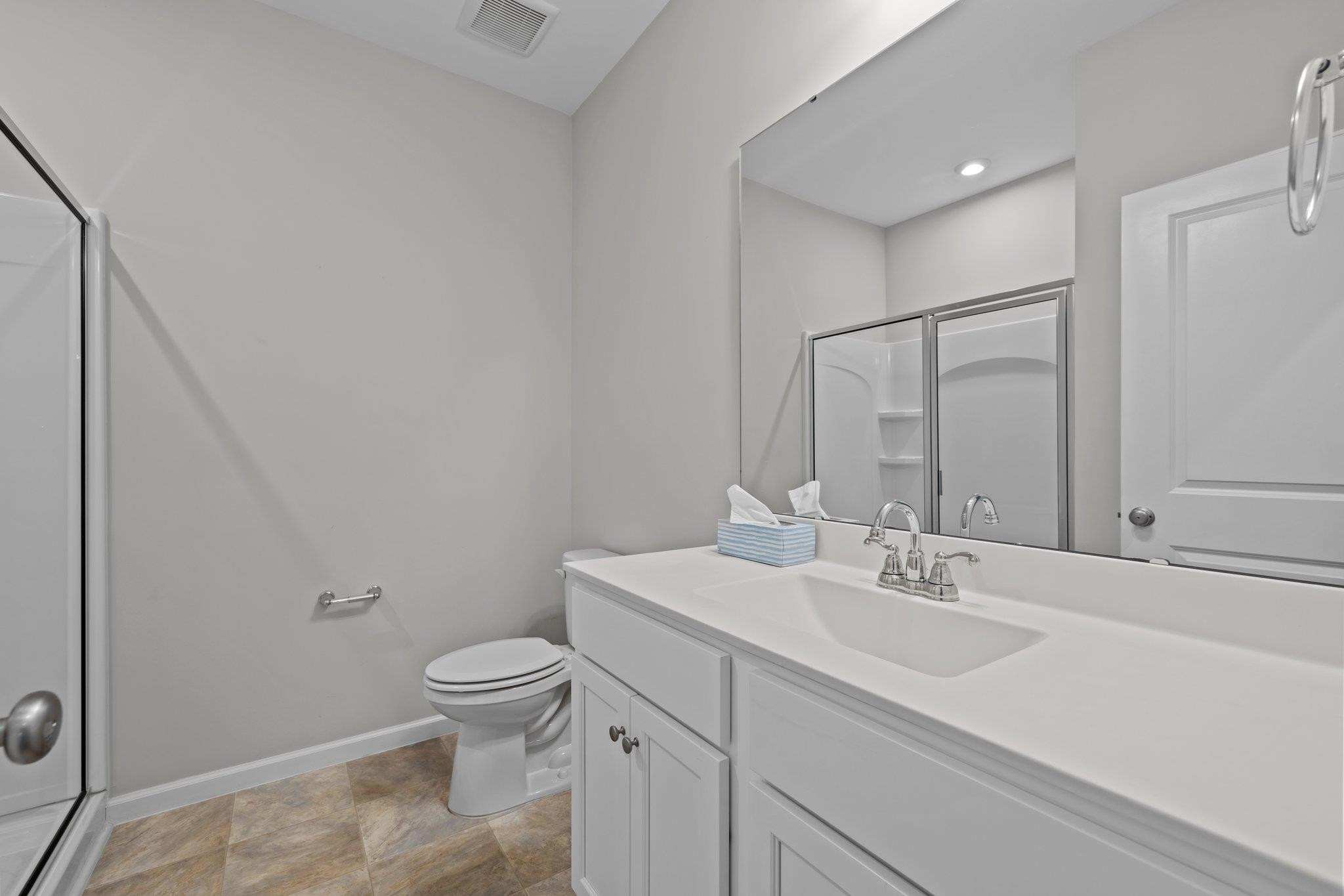 91 Stromness Path Clayton, NC 27527 - Photo 24 of 48 a bathroom with a sink a toilet and a mirror
