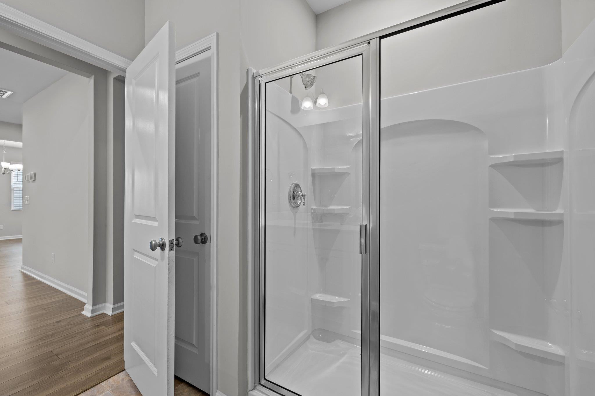 91 Stromness Path Clayton, NC 27527 - Photo 25 of 48 a bathroom with a glass shower door
