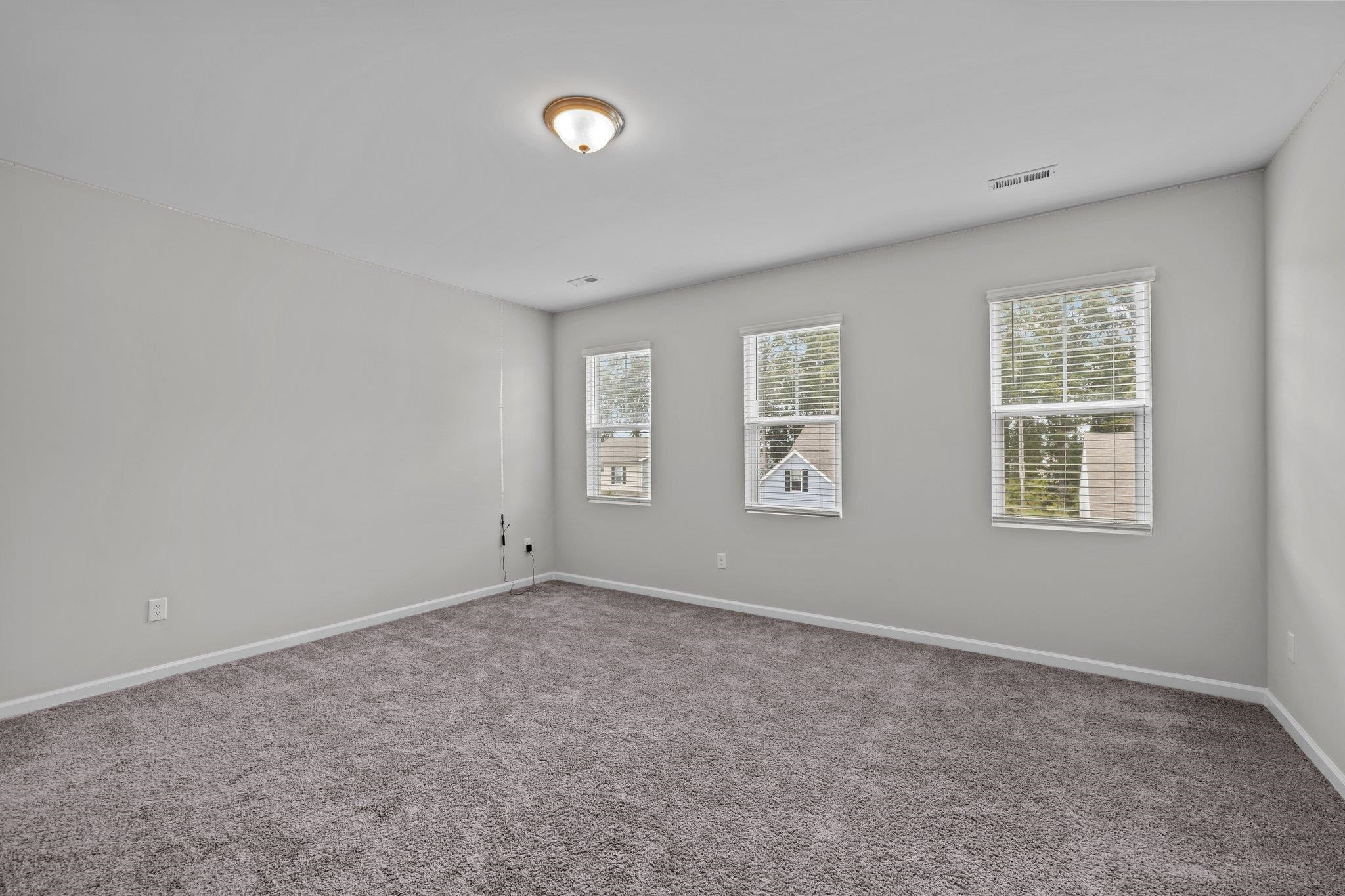 91 Stromness Path Clayton, NC 27527 - Photo 29 of 48 an empty room with windows