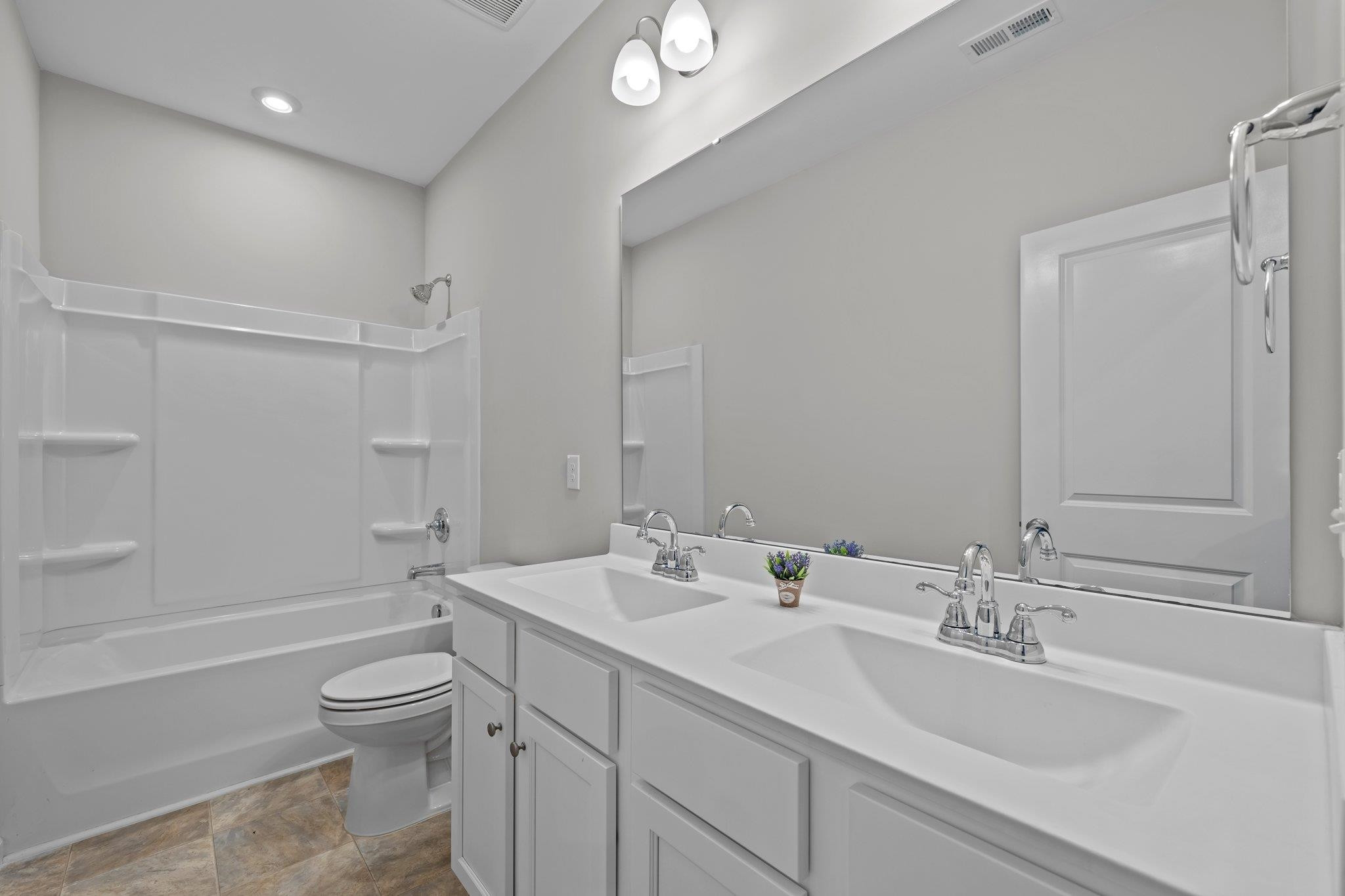 91 Stromness Path Clayton, NC 27527 - Photo 31 of 48 a bathroom with a sink a toilet and shower
