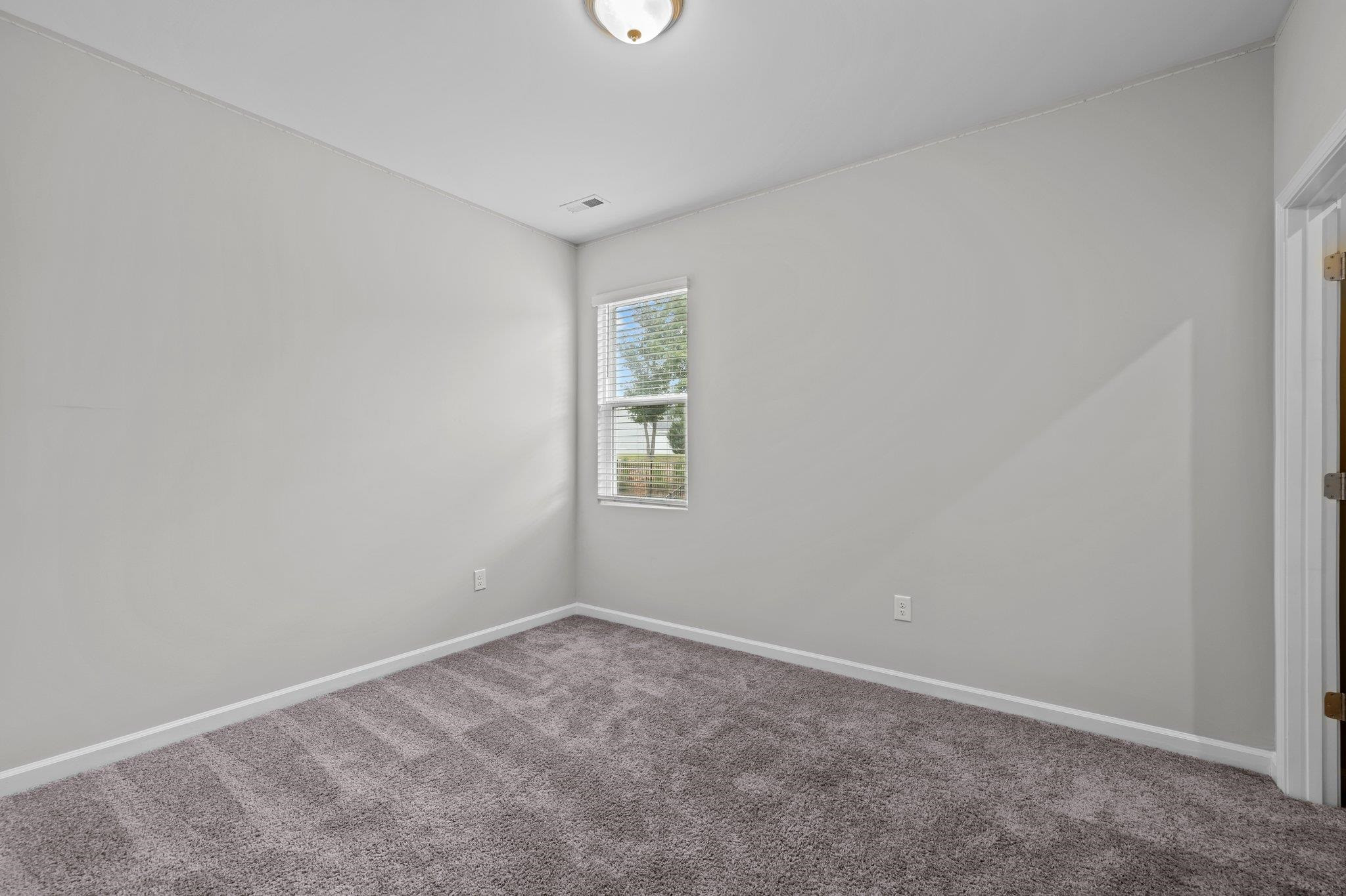 91 Stromness Path Clayton, NC 27527 - Photo 32 of 48 an empty room with a window