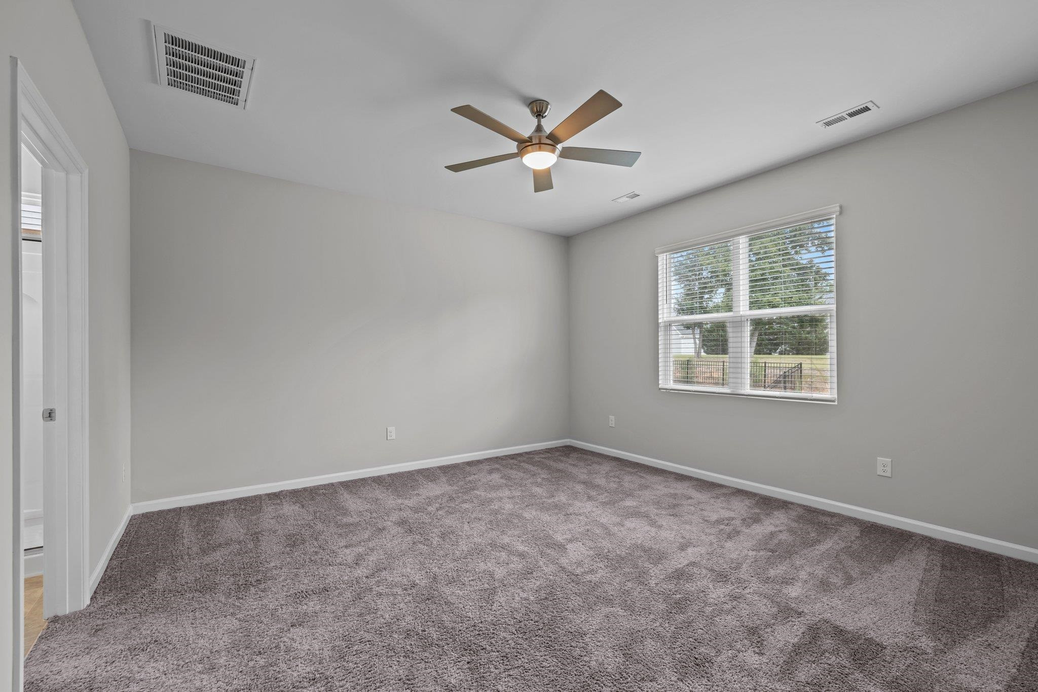91 Stromness Path Clayton, NC 27527 - Photo 36 of 48 an empty room with windows and fan