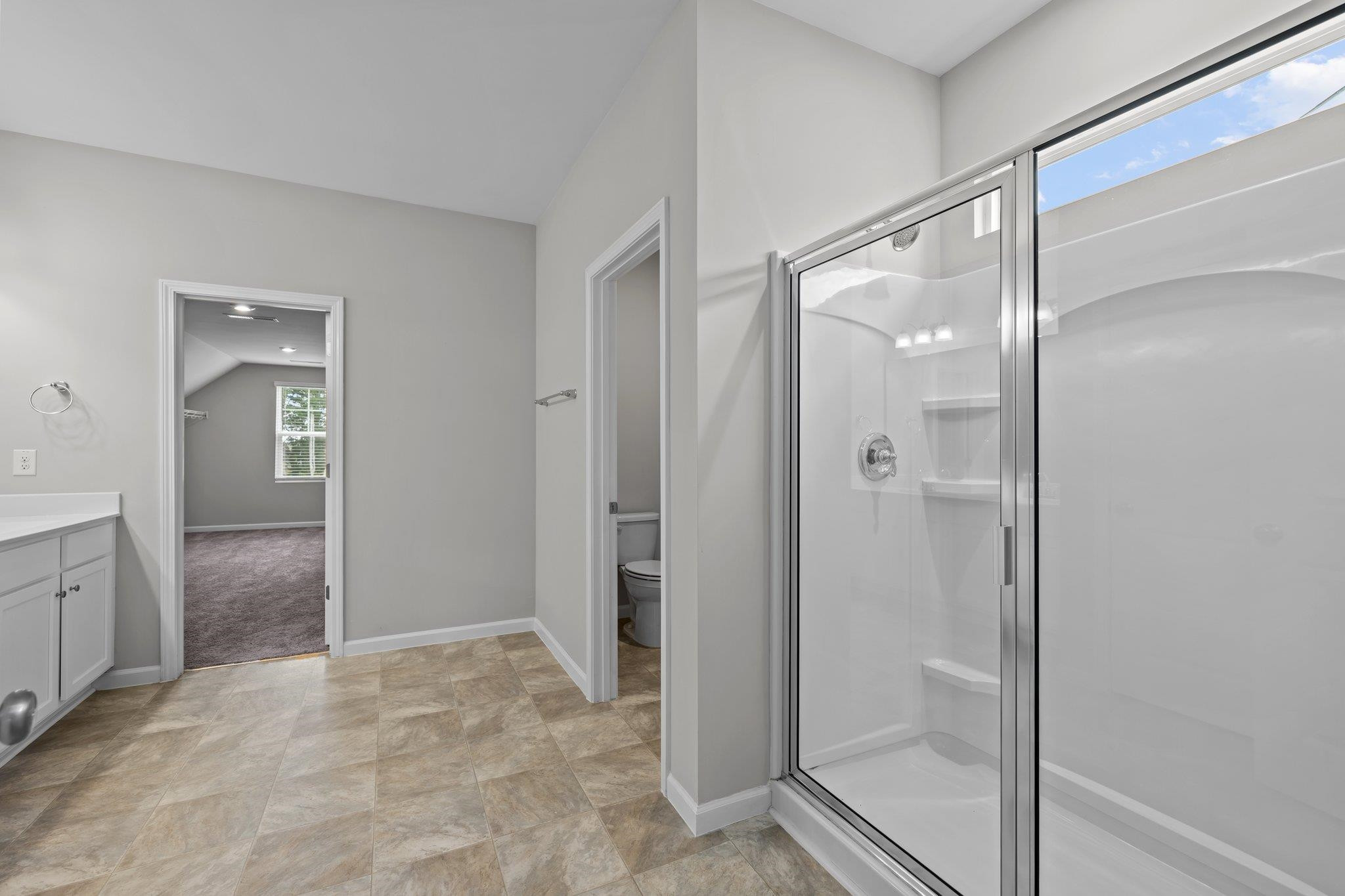 91 Stromness Path Clayton, NC 27527 - Photo 37 of 48 a bathroom with a glass shower door