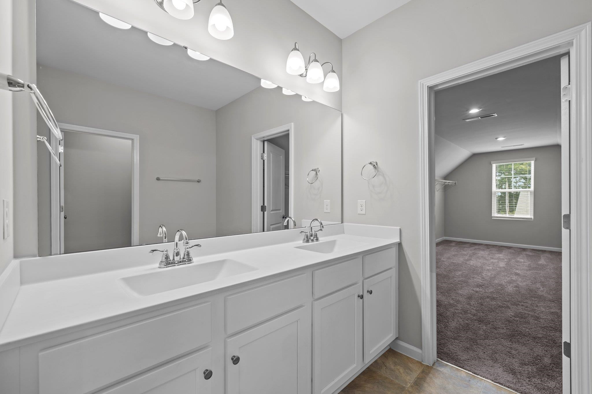 91 Stromness Path Clayton, NC 27527 - Photo 38 of 48 a bathroom with a double vanity sink and a mirror